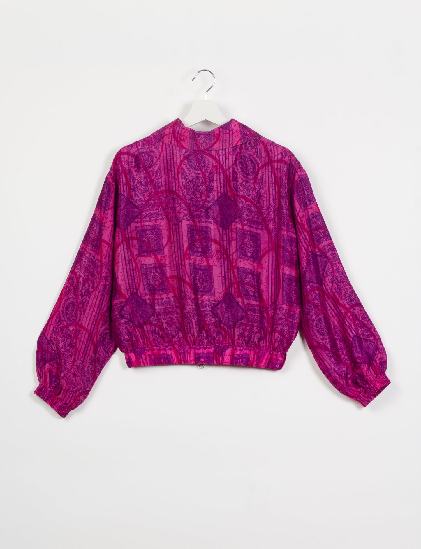 Stylish BOMBER JACKET, an upcycled clothing masterpiece with a cute cropped shape, elasticated details, and detachable metallic zipper. Contrast sari print lining adds a unique touch. Explore sustainable and eco-friendly fashion.