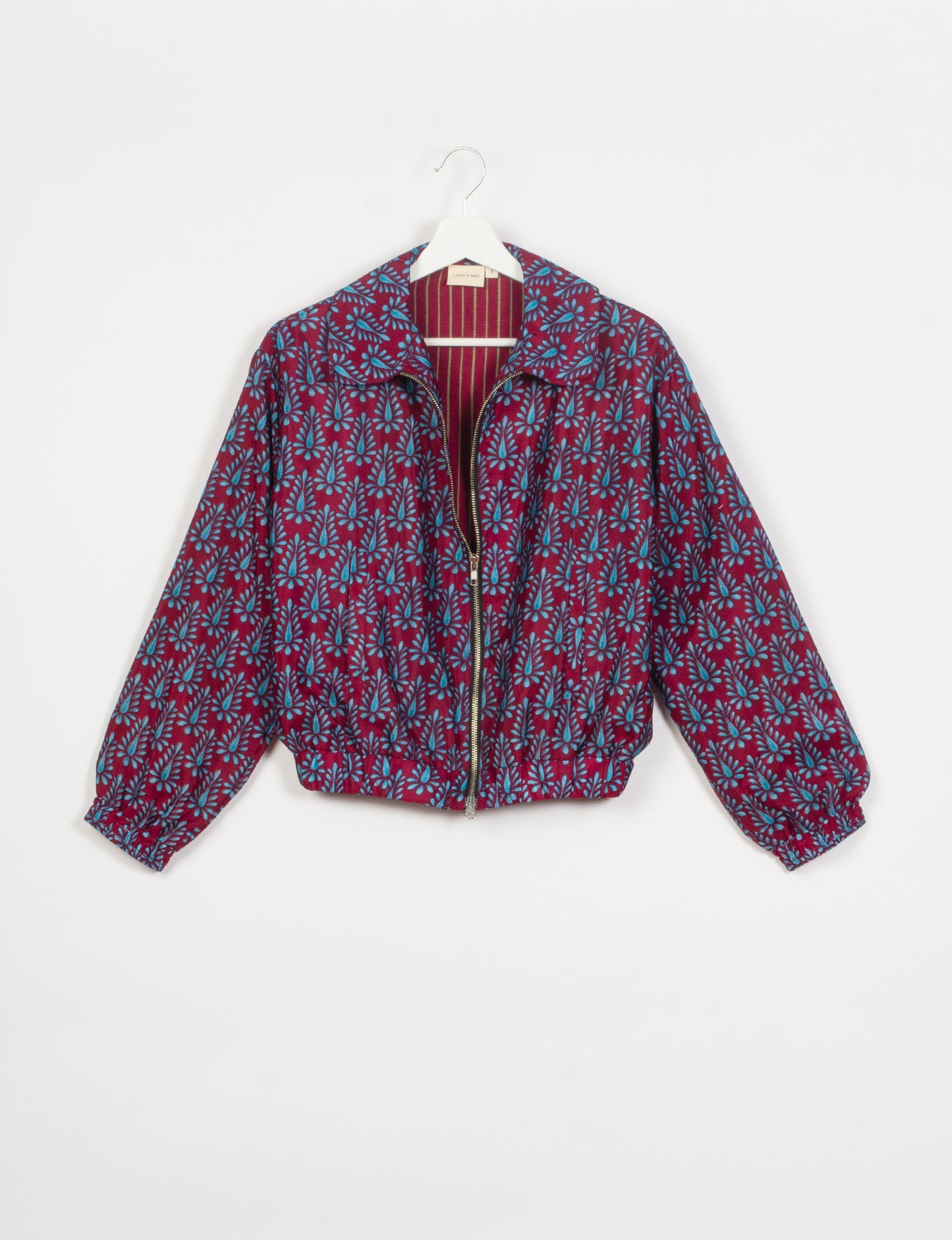 Stylish BOMBER JACKET, an upcycled clothing masterpiece with a cute cropped shape, elasticated details, and detachable metallic zipper. Contrast sari print lining adds a unique touch. Explore sustainable and eco-friendly fashion.