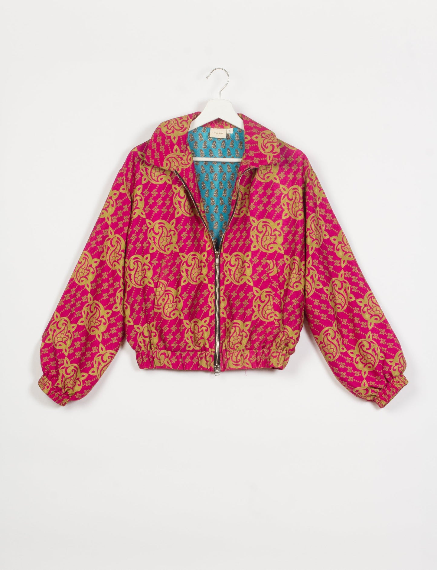 Stylish BOMBER JACKET, an upcycled clothing masterpiece with a cute cropped shape, elasticated details, and detachable metallic zipper. Contrast sari print lining adds a unique touch. Explore sustainable and eco-friendly fashion.