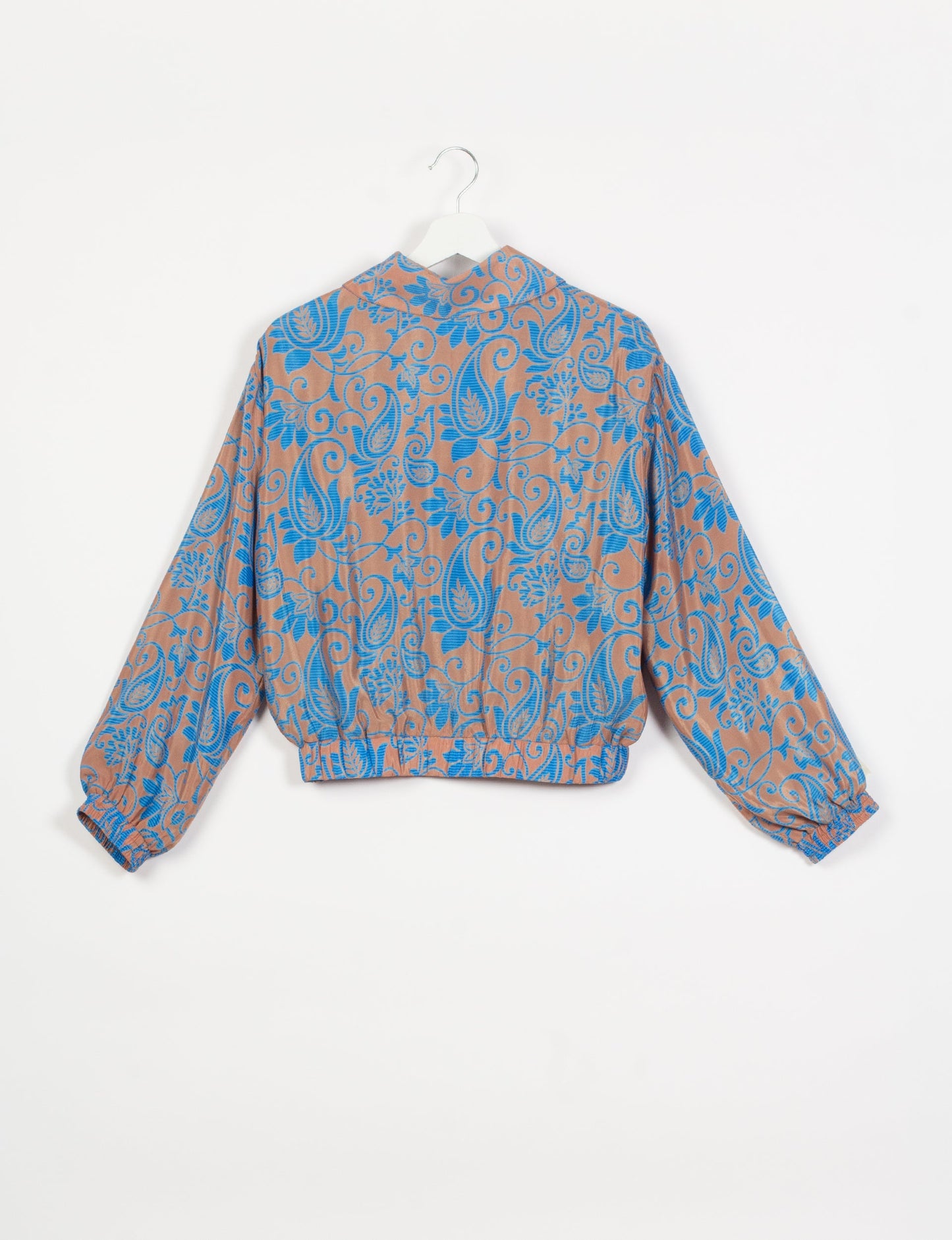 Stylish BOMBER JACKET, an upcycled clothing masterpiece with a cute cropped shape, elasticated details, and detachable metallic zipper. Contrast sari print lining adds a unique touch. Explore sustainable and eco-friendly fashion.