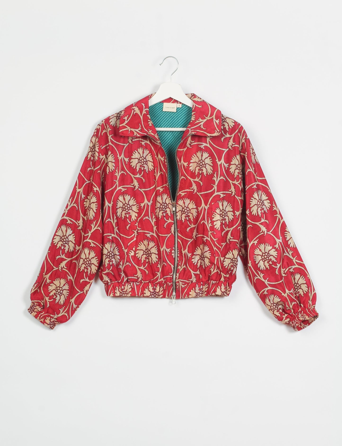 Stylish BOMBER JACKET, an upcycled clothing masterpiece with a cute cropped shape, elasticated details, and detachable metallic zipper. Contrast sari print lining adds a unique touch. Explore sustainable and eco-friendly fashion.