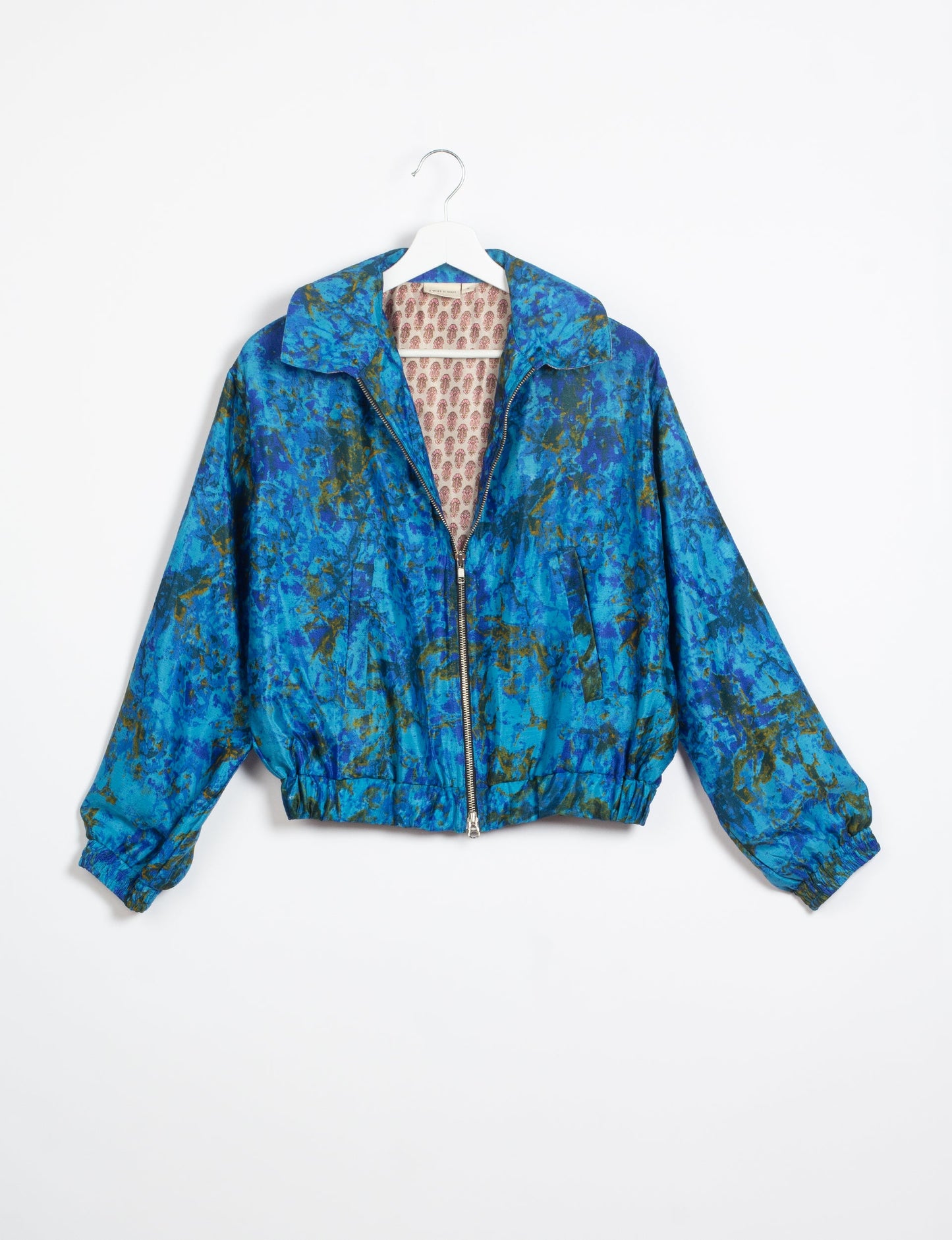 Stylish BOMBER JACKET, an upcycled clothing masterpiece with a cute cropped shape, elasticated details, and detachable metallic zipper. Contrast sari print lining adds a unique touch. Explore sustainable and eco-friendly fashion.