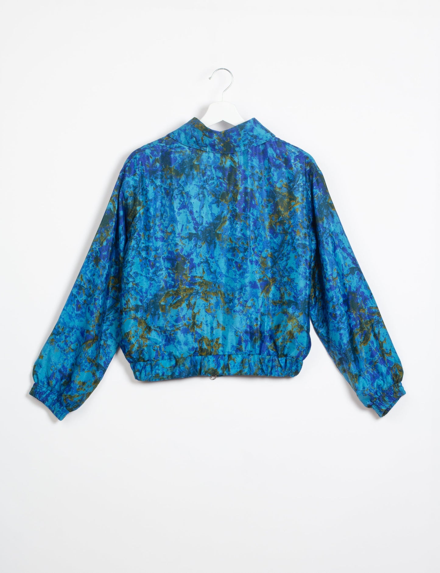 Stylish BOMBER JACKET, an upcycled clothing masterpiece with a cute cropped shape, elasticated details, and detachable metallic zipper. Contrast sari print lining adds a unique touch. Explore sustainable and eco-friendly fashion.