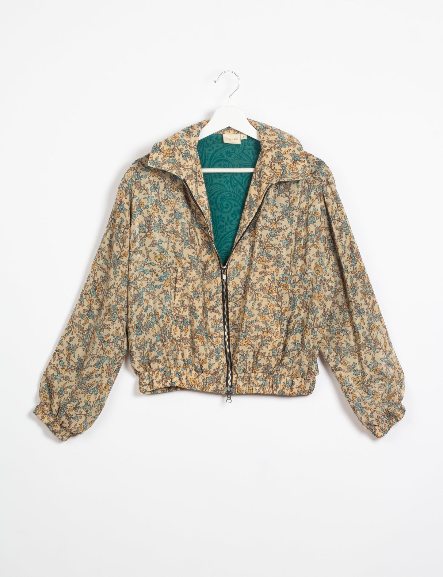 Stylish BOMBER JACKET, an upcycled clothing masterpiece with a cute cropped shape, elasticated details, and detachable metallic zipper. Contrast sari print lining adds a unique touch. Explore sustainable and eco-friendly fashion.