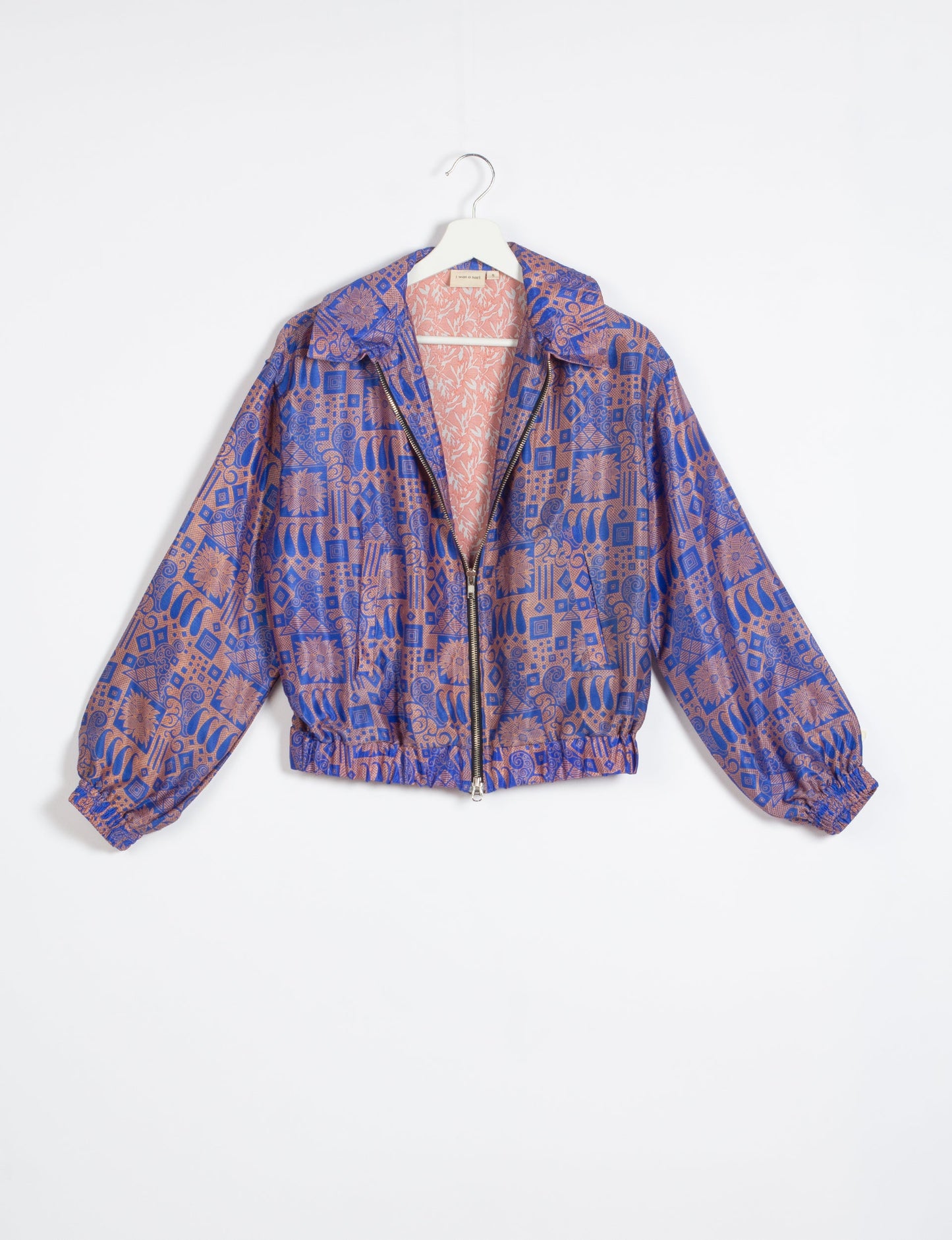 Stylish BOMBER JACKET, an upcycled clothing masterpiece with a cute cropped shape, elasticated details, and detachable metallic zipper. Contrast sari print lining adds a unique touch. Explore sustainable and eco-friendly fashion.