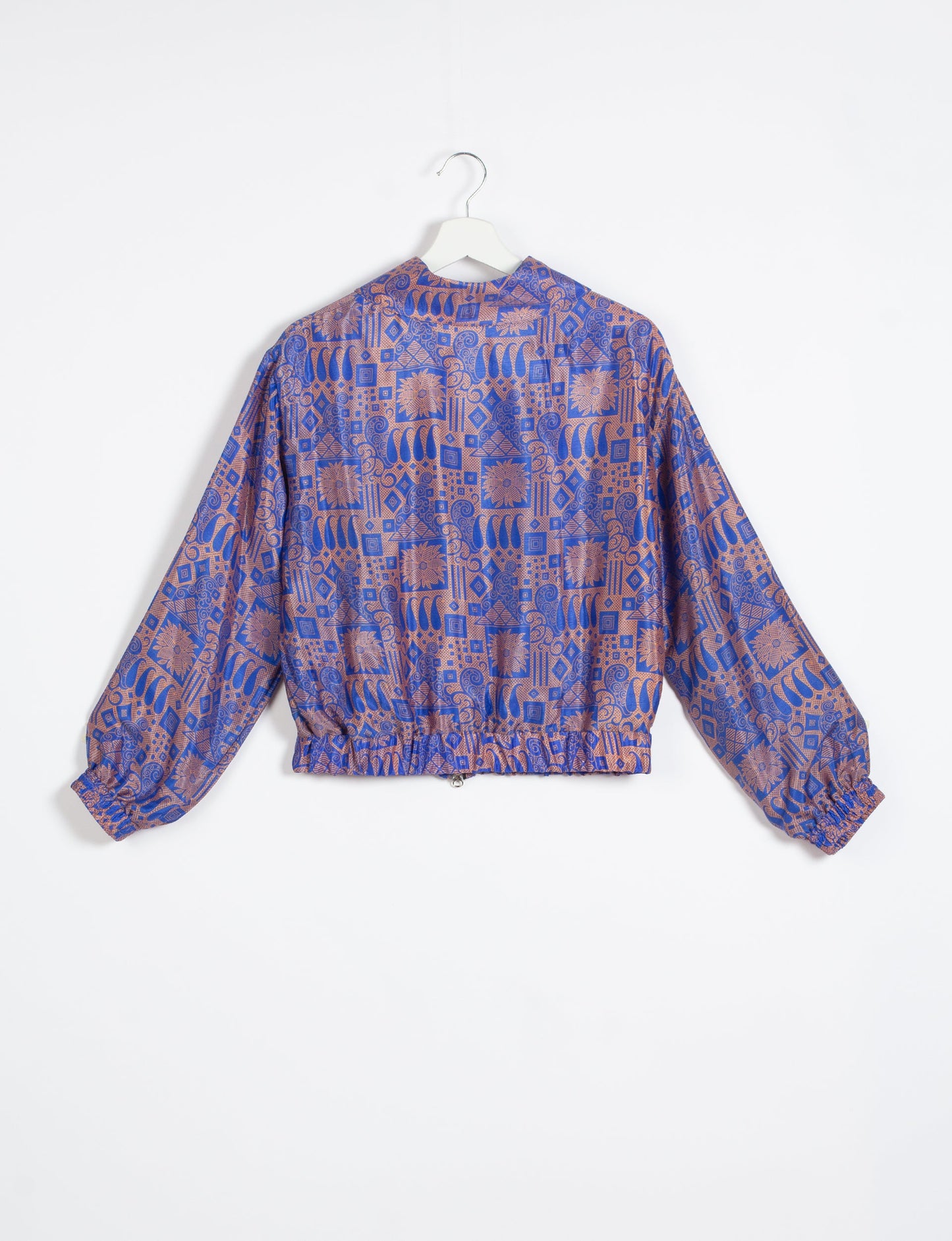 Stylish BOMBER JACKET, an upcycled clothing masterpiece with a cute cropped shape, elasticated details, and detachable metallic zipper. Contrast sari print lining adds a unique touch. Explore sustainable and eco-friendly fashion.