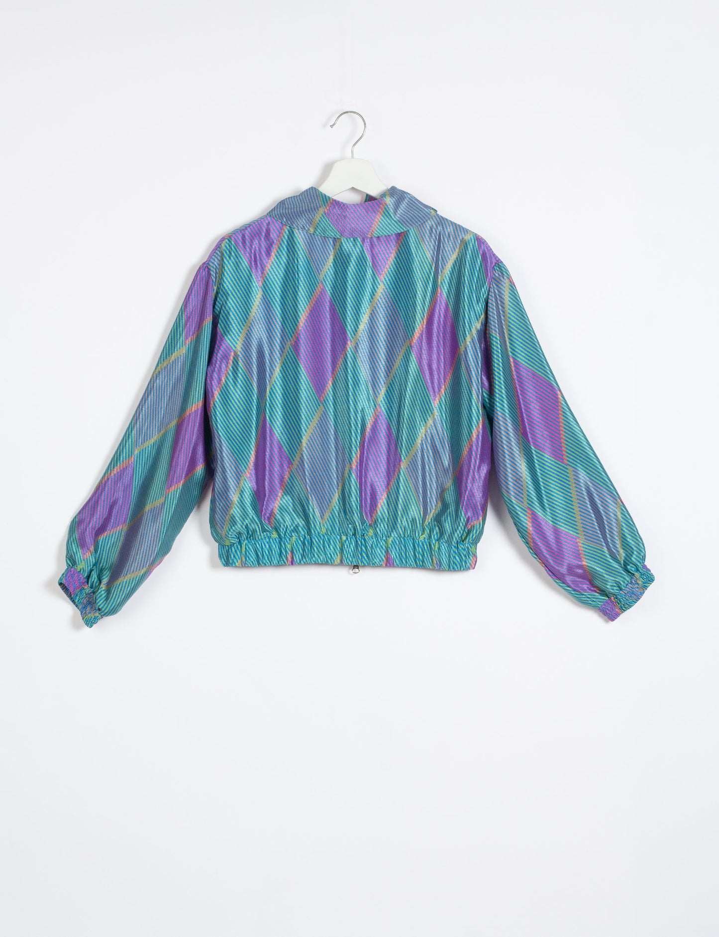 Stylish BOMBER JACKET, an upcycled clothing masterpiece with a cute cropped shape, elasticated details, and detachable metallic zipper. Contrast sari print lining adds a unique touch. Explore sustainable and eco-friendly fashion.