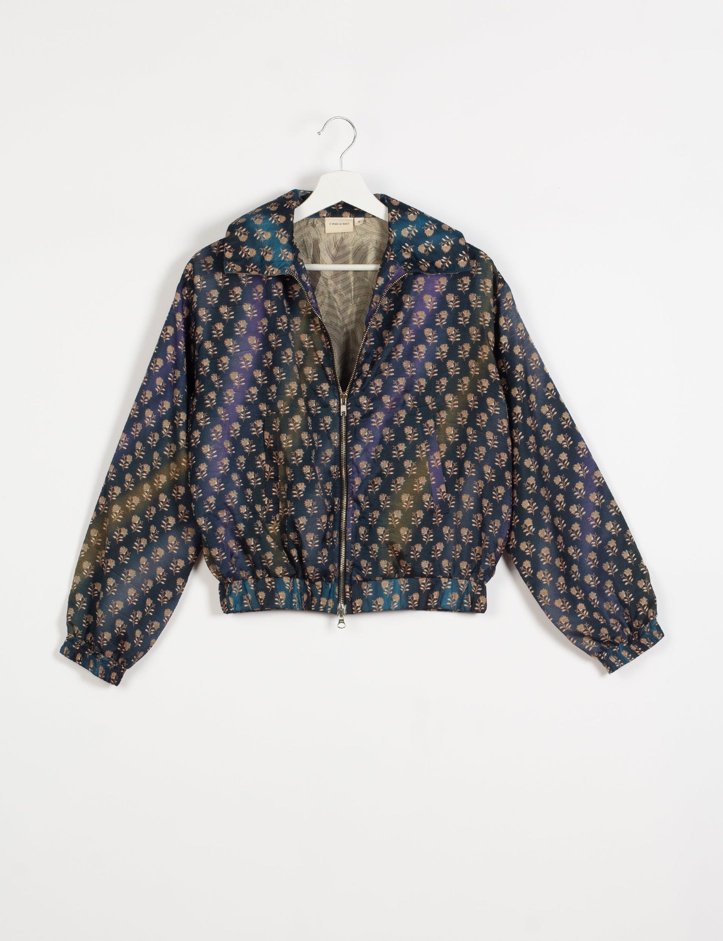 Stylish BOMBER JACKET, an upcycled clothing masterpiece with a cute cropped shape, elasticated details, and detachable metallic zipper. Contrast sari print lining adds a unique touch. Explore sustainable and eco-friendly fashion.