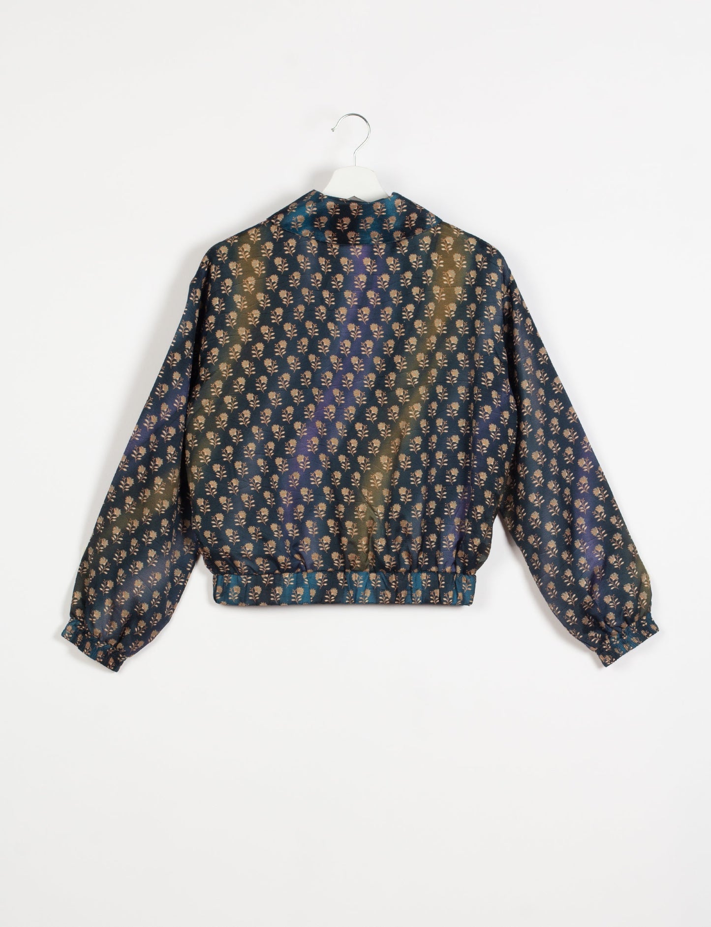 Stylish BOMBER JACKET, an upcycled clothing masterpiece with a cute cropped shape, elasticated details, and detachable metallic zipper. Contrast sari print lining adds a unique touch. Explore sustainable and eco-friendly fashion.