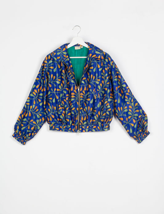 Stylish BOMBER JACKET, an upcycled clothing masterpiece with a cute cropped shape, elasticated details, and detachable metallic zipper. Contrast sari print lining adds a unique touch. Explore sustainable and eco-friendly fashion.