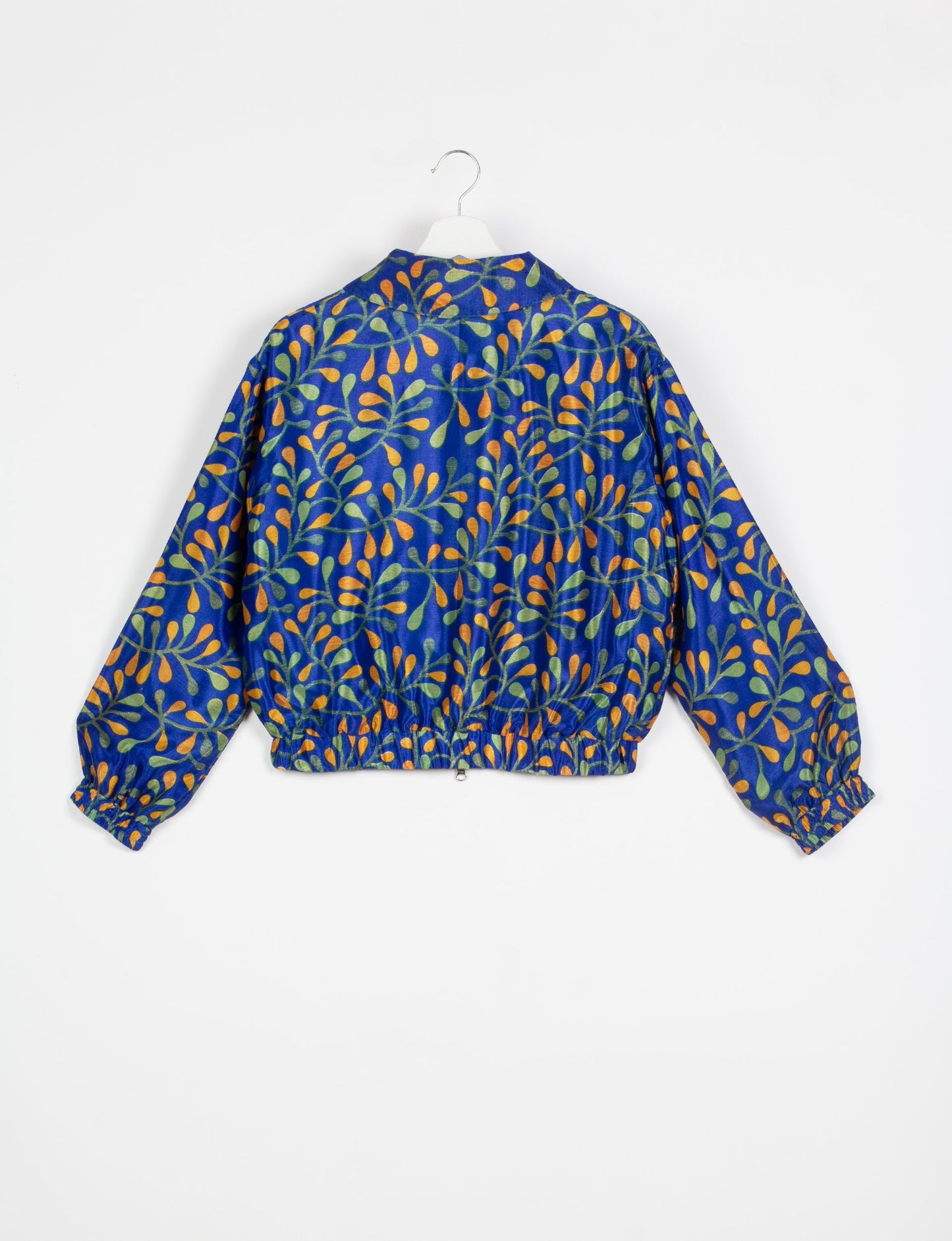 Stylish BOMBER JACKET, an upcycled clothing masterpiece with a cute cropped shape, elasticated details, and detachable metallic zipper. Contrast sari print lining adds a unique touch. Explore sustainable and eco-friendly fashion.