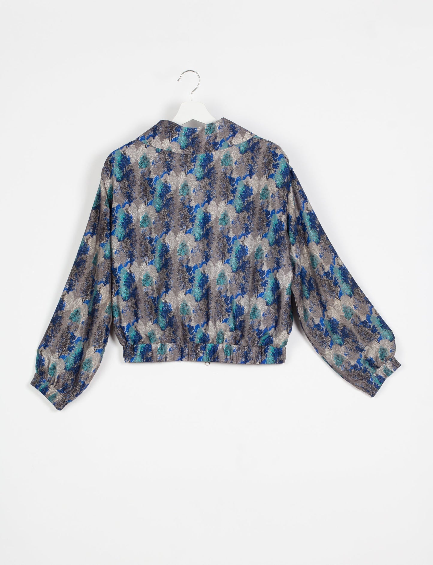 Stylish BOMBER JACKET, an upcycled clothing masterpiece with a cute cropped shape, elasticated details, and detachable metallic zipper. Contrast sari print lining adds a unique touch. Explore sustainable and eco-friendly fashion.