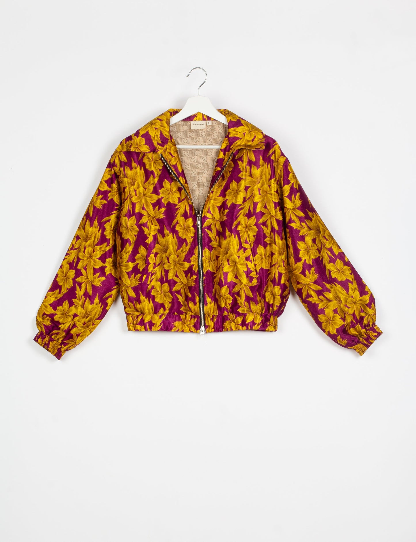 Stylish BOMBER JACKET, an upcycled clothing masterpiece with a cute cropped shape, elasticated details, and detachable metallic zipper. Contrast sari print lining adds a unique touch. Explore sustainable and eco-friendly fashion.