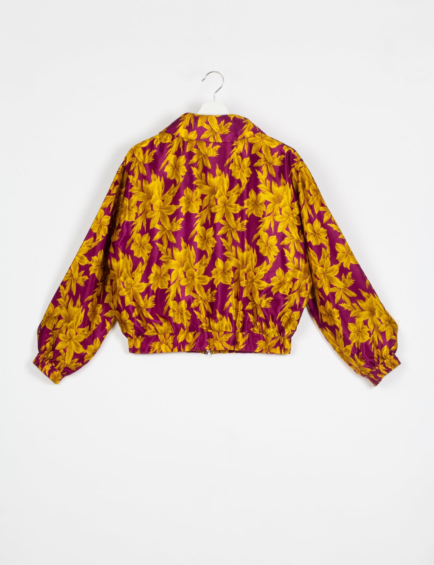 Stylish BOMBER JACKET, an upcycled clothing masterpiece with a cute cropped shape, elasticated details, and detachable metallic zipper. Contrast sari print lining adds a unique touch. Explore sustainable and eco-friendly fashion.