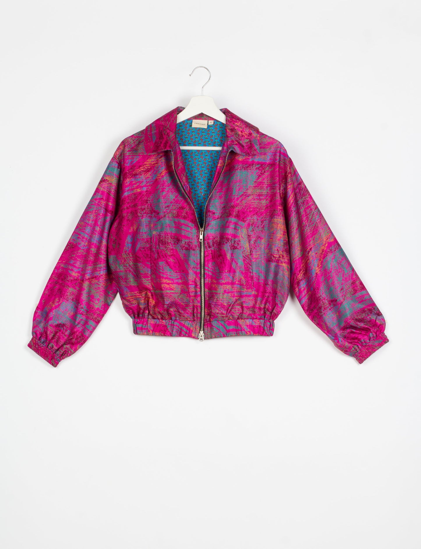 Stylish BOMBER JACKET, an upcycled clothing masterpiece with a cute cropped shape, elasticated details, and detachable metallic zipper. Contrast sari print lining adds a unique touch. Explore sustainable and eco-friendly fashion.