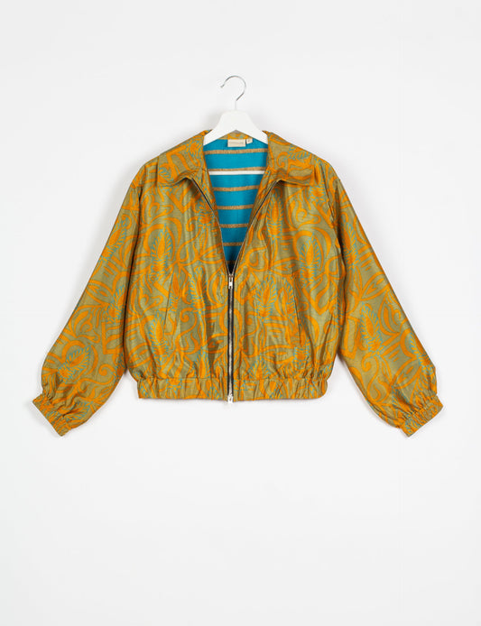 Stylish BOMBER JACKET, an upcycled clothing masterpiece with a cute cropped shape, elasticated details, and detachable metallic zipper. Contrast sari print lining adds a unique touch. Explore sustainable and eco-friendly fashion.