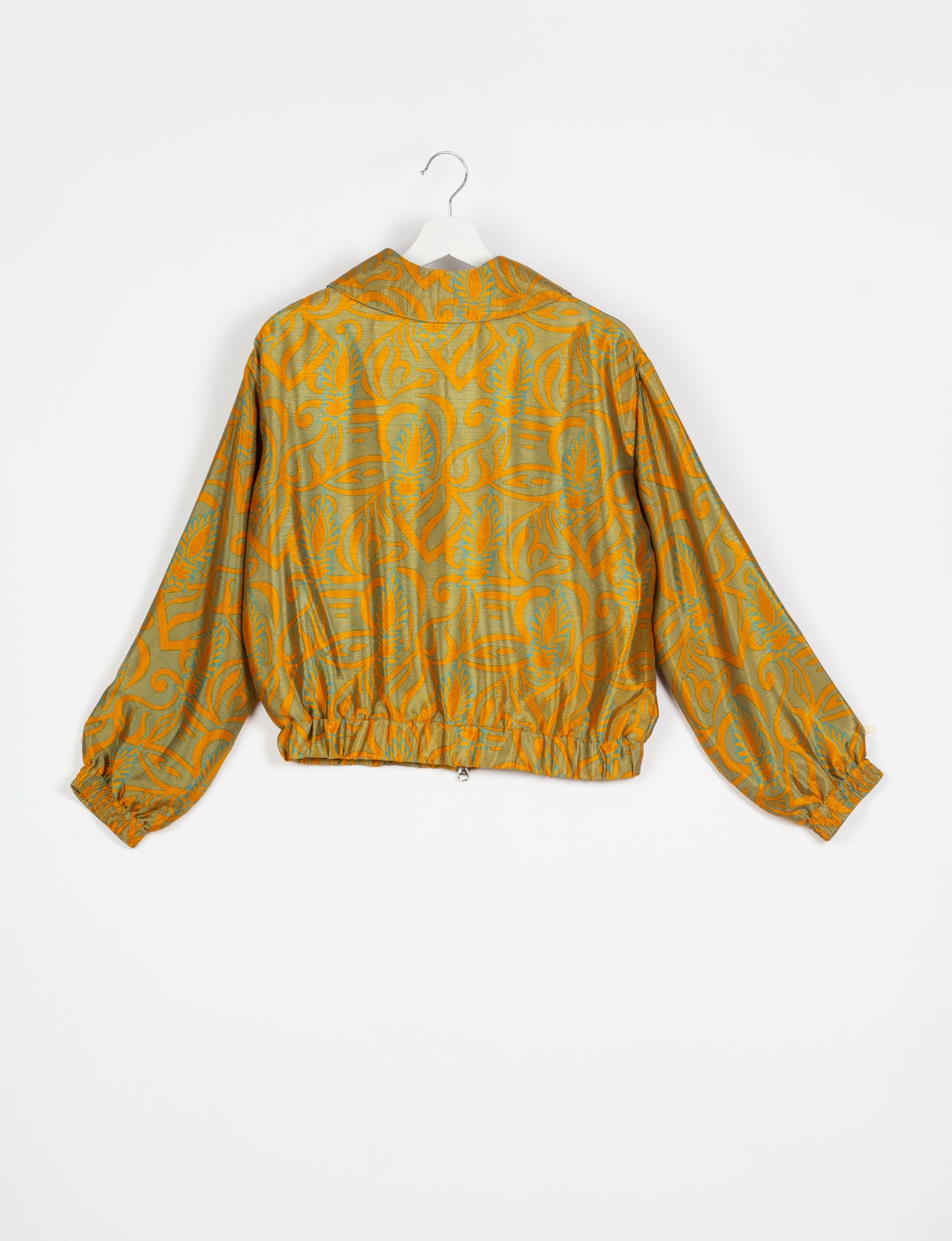 Stylish BOMBER JACKET, an upcycled clothing masterpiece with a cute cropped shape, elasticated details, and detachable metallic zipper. Contrast sari print lining adds a unique touch. Explore sustainable and eco-friendly fashion.