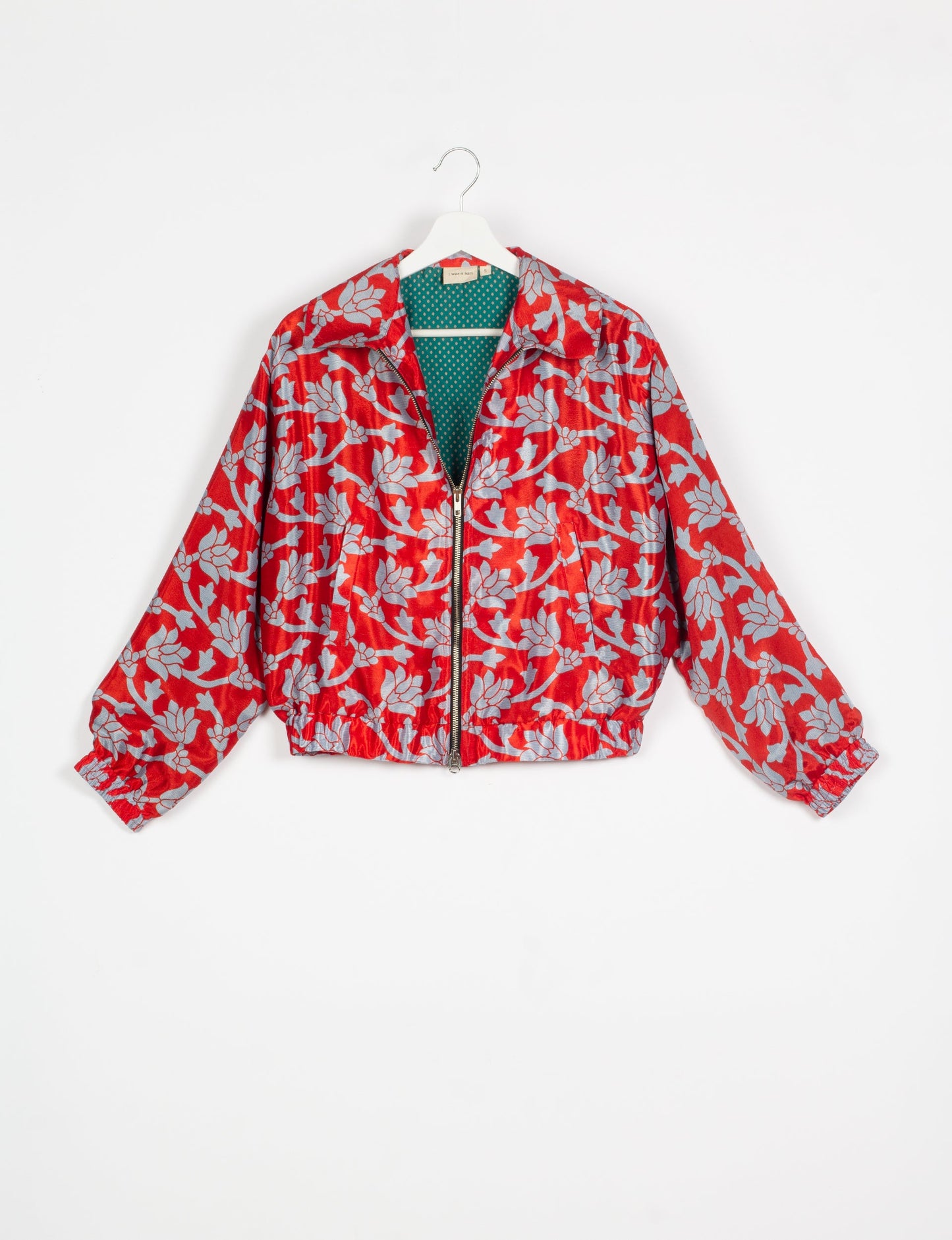 Stylish BOMBER JACKET, an upcycled clothing masterpiece with a cute cropped shape, elasticated details, and detachable metallic zipper. Contrast sari print lining adds a unique touch. Explore sustainable and eco-friendly fashion.