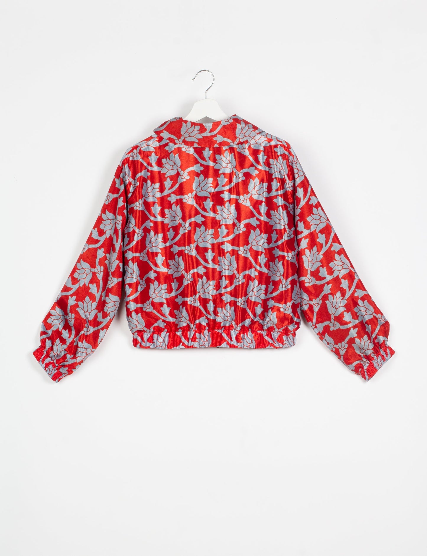 Stylish BOMBER JACKET, an upcycled clothing masterpiece with a cute cropped shape, elasticated details, and detachable metallic zipper. Contrast sari print lining adds a unique touch. Explore sustainable and eco-friendly fashion.