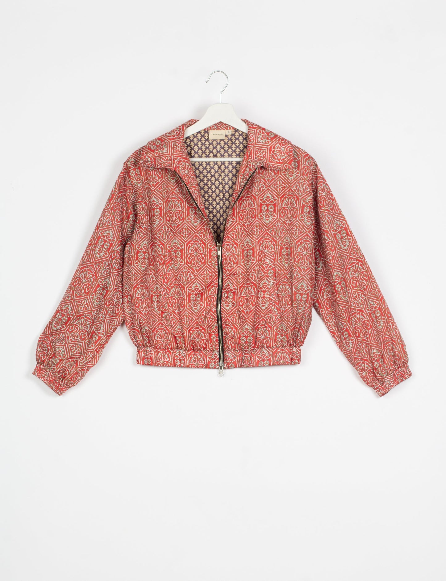 Stylish BOMBER JACKET, an upcycled clothing masterpiece with a cute cropped shape, elasticated details, and detachable metallic zipper. Contrast sari print lining adds a unique touch. Explore sustainable and eco-friendly fashion.