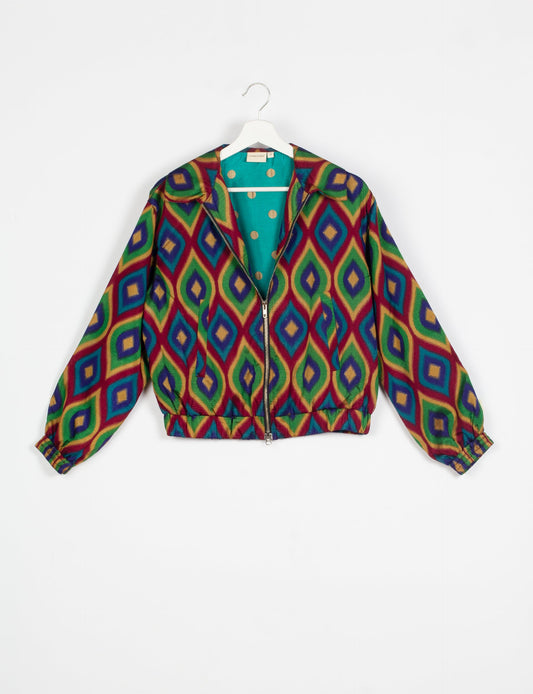 Stylish BOMBER JACKET, an upcycled clothing masterpiece with a cute cropped shape, elasticated details, and detachable metallic zipper. Contrast sari print lining adds a unique touch. Explore sustainable and eco-friendly fashion.