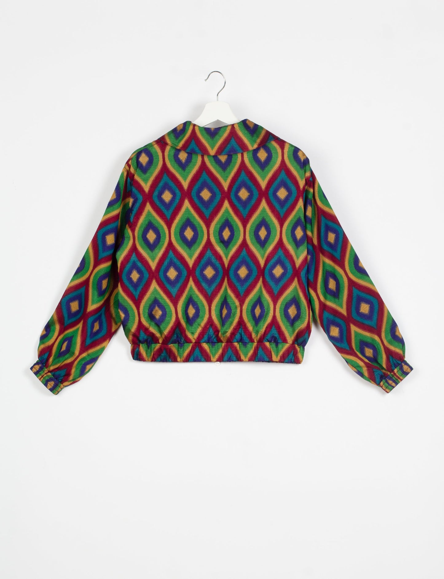 Stylish BOMBER JACKET, an upcycled clothing masterpiece with a cute cropped shape, elasticated details, and detachable metallic zipper. Contrast sari print lining adds a unique touch. Explore sustainable and eco-friendly fashion.