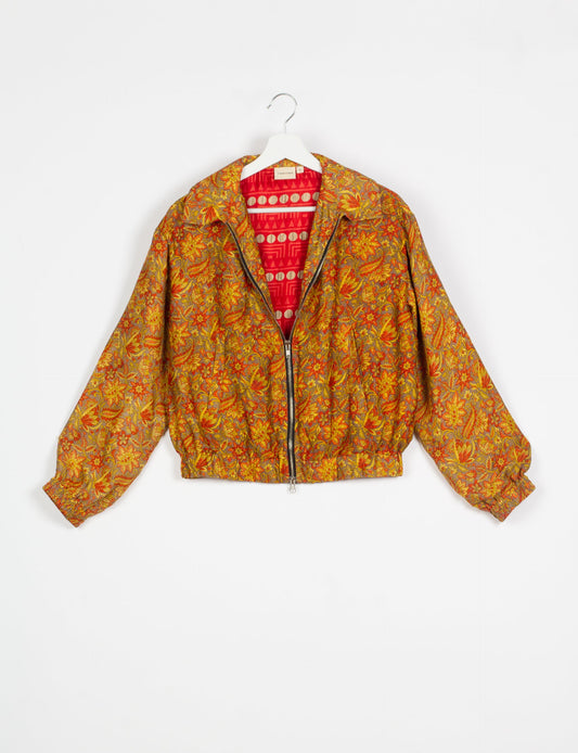 Stylish BOMBER JACKET, an upcycled clothing masterpiece with a cute cropped shape, elasticated details, and detachable metallic zipper. Contrast sari print lining adds a unique touch. Explore sustainable and eco-friendly fashion.