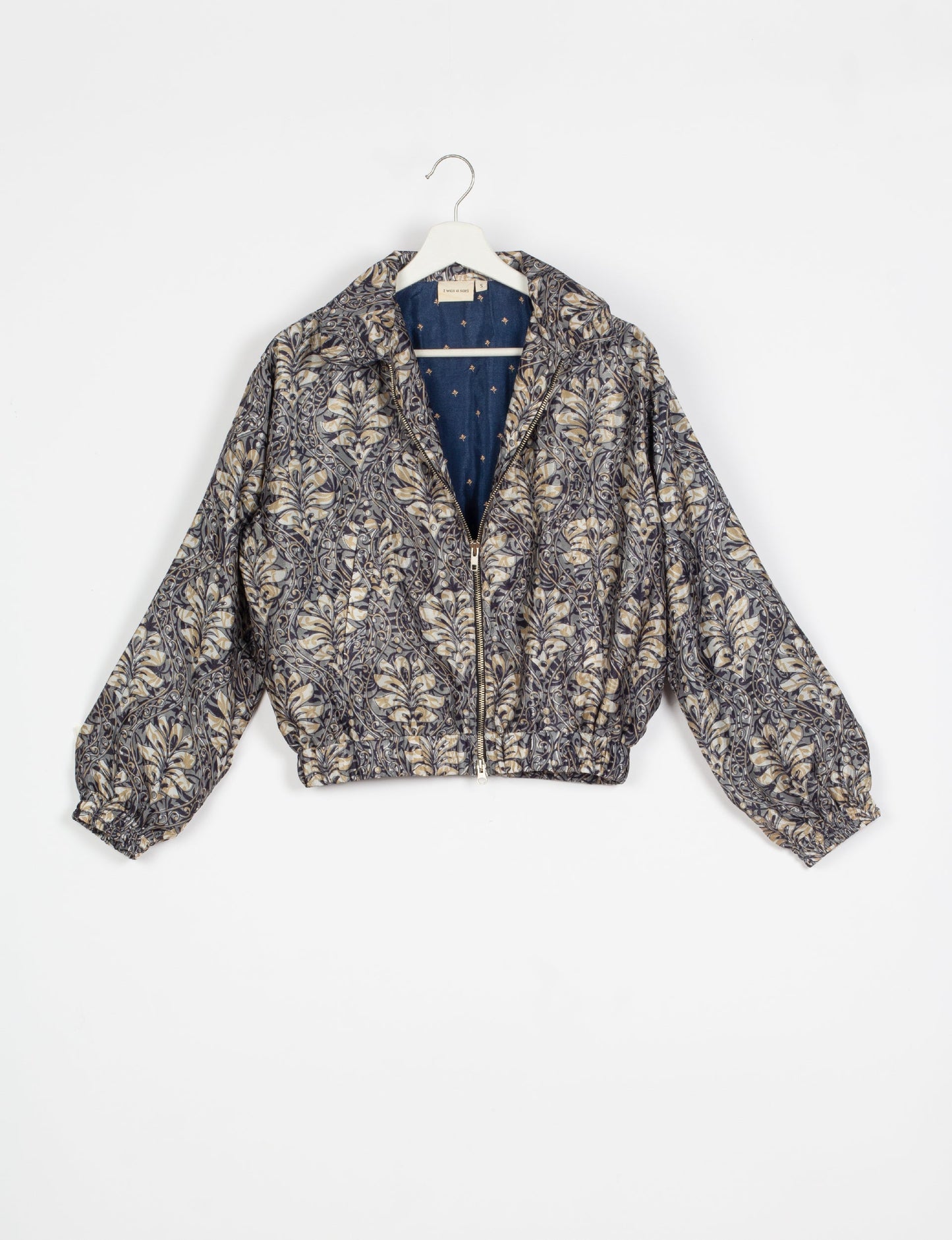 Stylish BOMBER JACKET, an upcycled clothing masterpiece with a cute cropped shape, elasticated details, and detachable metallic zipper. Contrast sari print lining adds a unique touch. Explore sustainable and eco-friendly fashion.