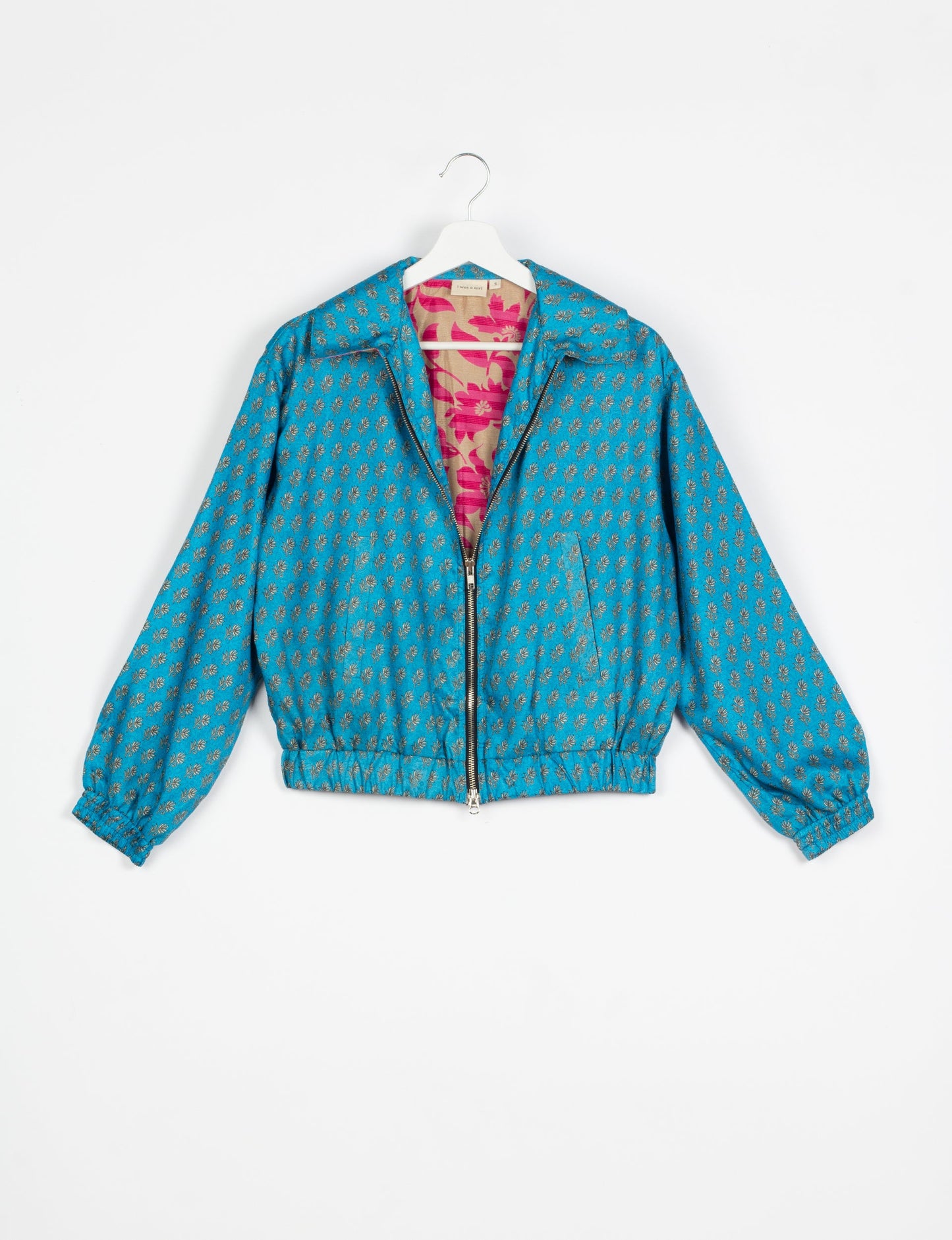 Stylish BOMBER JACKET, an upcycled clothing masterpiece with a cute cropped shape, elasticated details, and detachable metallic zipper. Contrast sari print lining adds a unique touch. Explore sustainable and eco-friendly fashion.