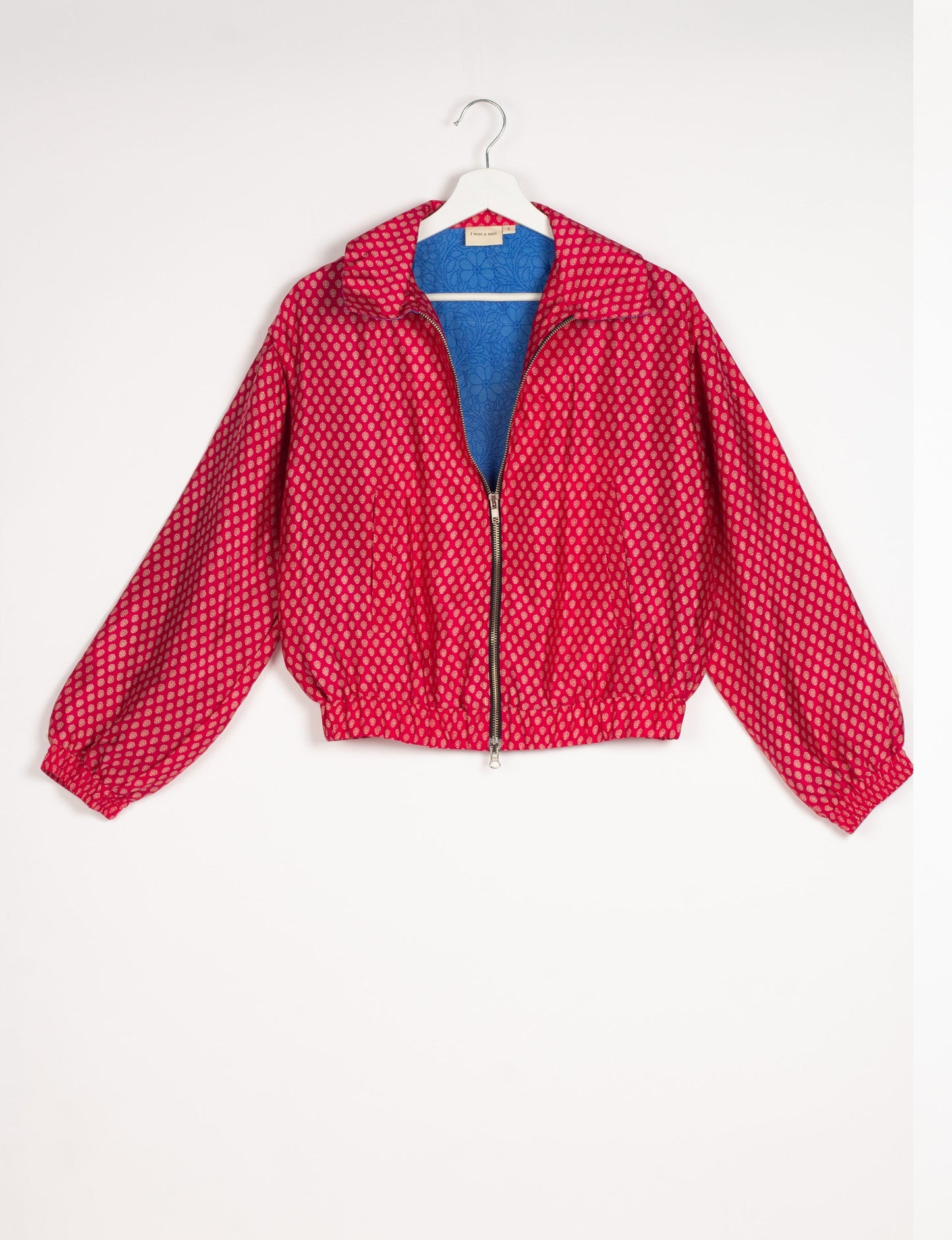 Stylish BOMBER JACKET, an upcycled clothing masterpiece with a cute cropped shape, elasticated details, and detachable metallic zipper. Contrast sari print lining adds a unique touch. Explore sustainable and eco-friendly fashion.