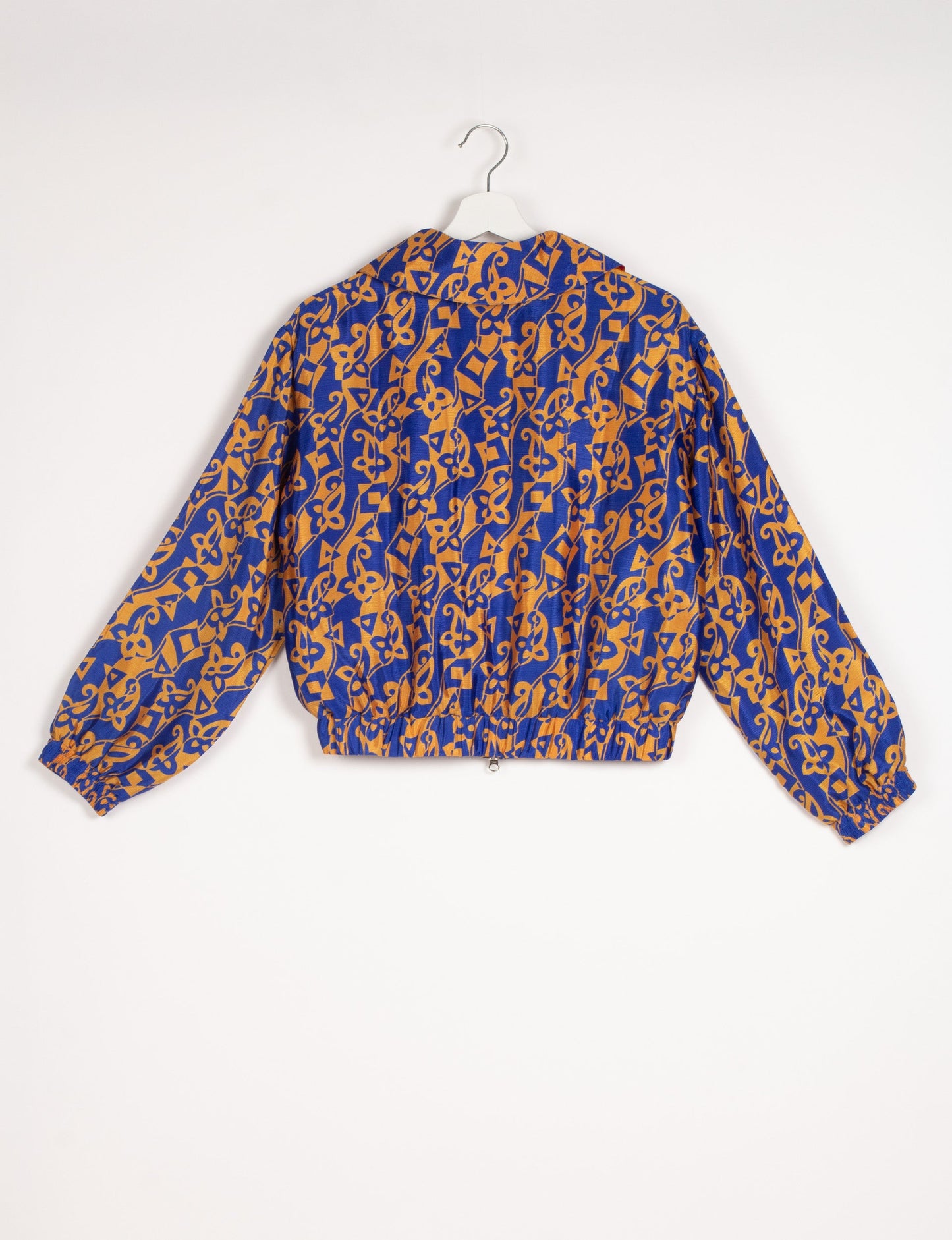 Stylish BOMBER JACKET, an upcycled clothing masterpiece with a cute cropped shape, elasticated details, and detachable metallic zipper. Contrast sari print lining adds a unique touch. Explore sustainable and eco-friendly fashion.