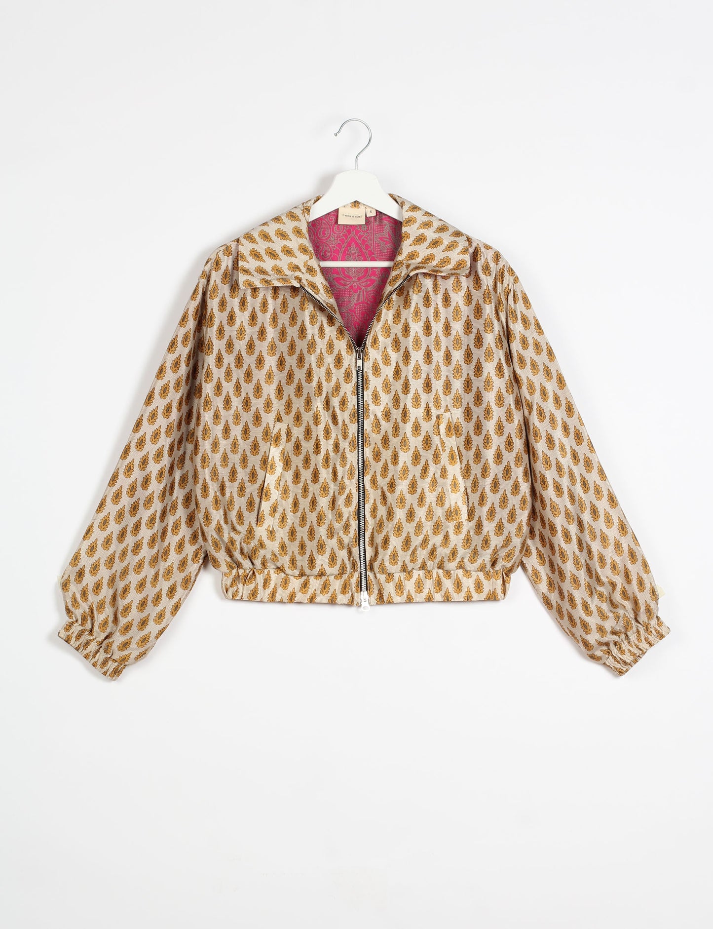 Stylish BOMBER JACKET, an upcycled clothing masterpiece with a cute cropped shape, elasticated details, and detachable metallic zipper. Contrast sari print lining adds a unique touch. Explore sustainable and eco-friendly fashion.