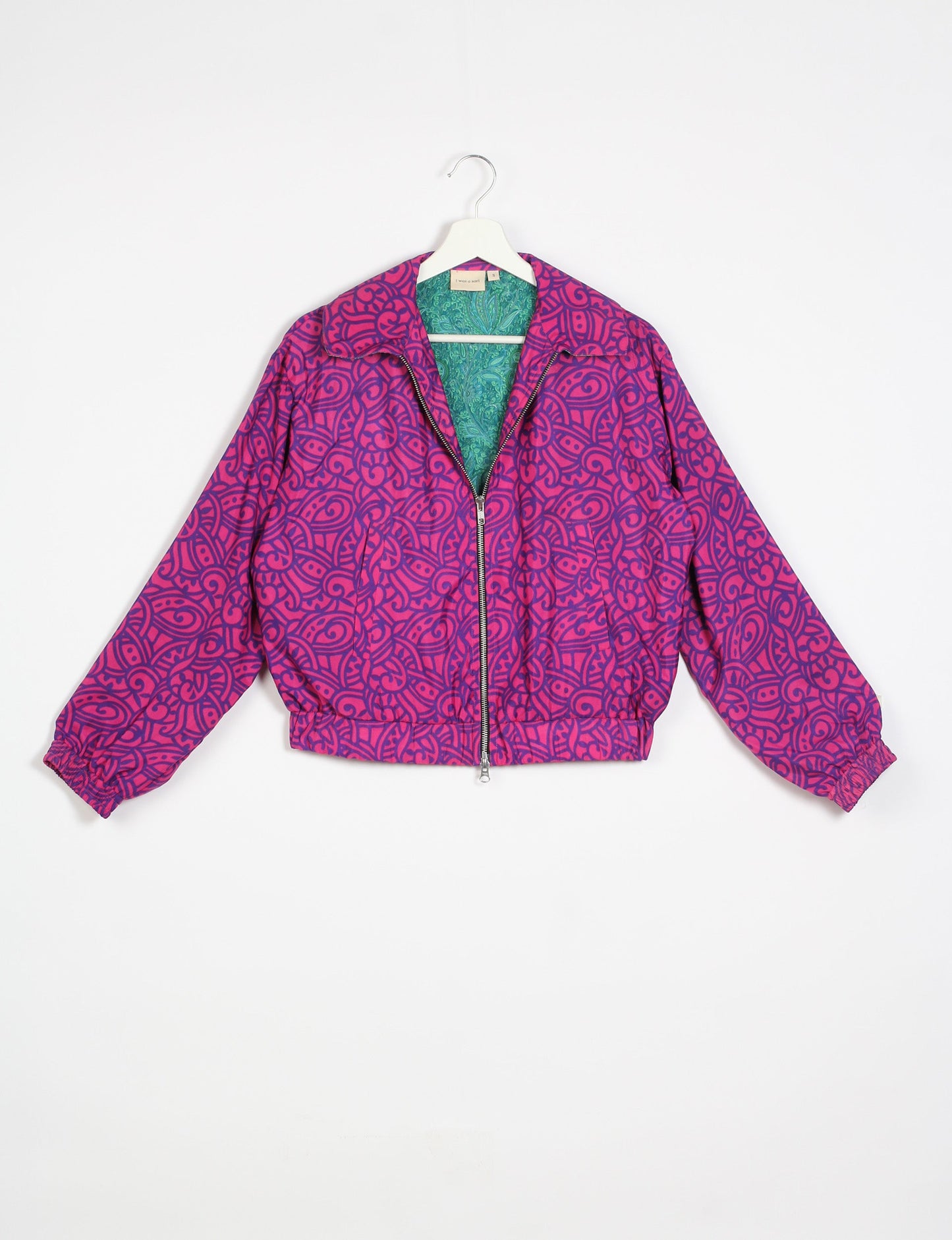 Stylish BOMBER JACKET, an upcycled clothing masterpiece with a cute cropped shape, elasticated details, and detachable metallic zipper. Contrast sari print lining adds a unique touch. Explore sustainable and eco-friendly fashion.