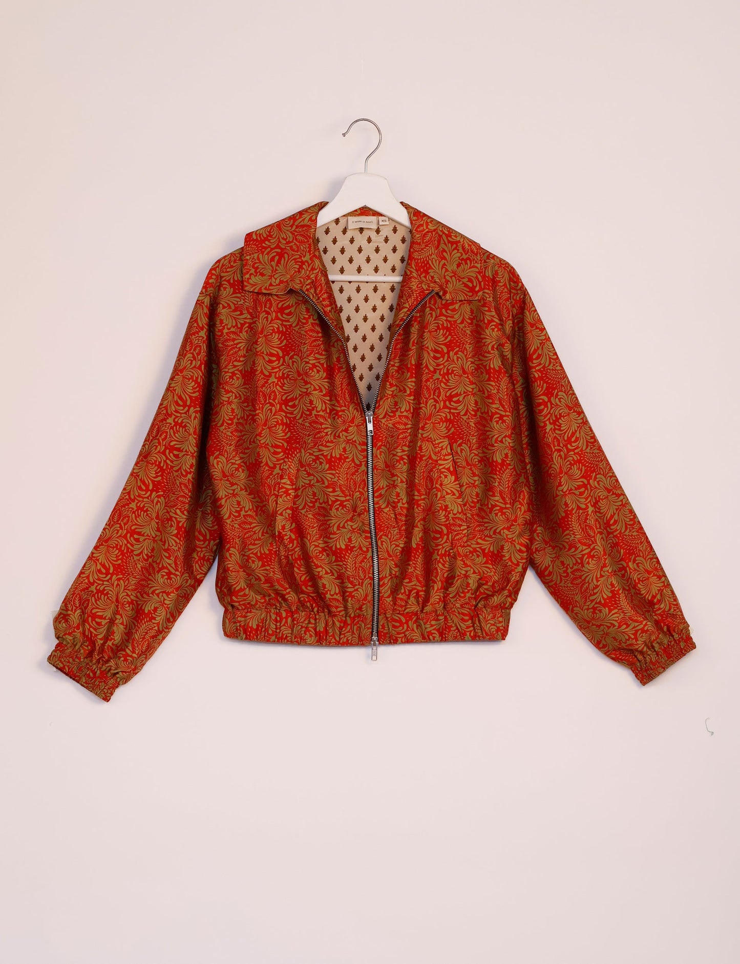 Stylish BOMBER JACKET, an upcycled clothing masterpiece with a cute cropped shape, elasticated details, and detachable metallic zipper. Contrast sari print lining adds a unique touch. Explore sustainable and eco-friendly fashion.