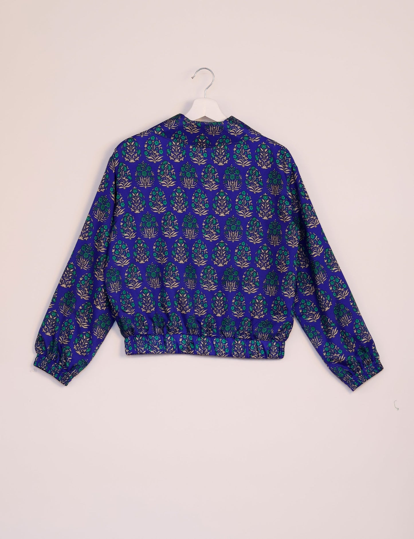 Stylish BOMBER JACKET, an upcycled clothing masterpiece with a cute cropped shape, elasticated details, and detachable metallic zipper. Contrast sari print lining adds a unique touch. Explore sustainable and eco-friendly fashion.