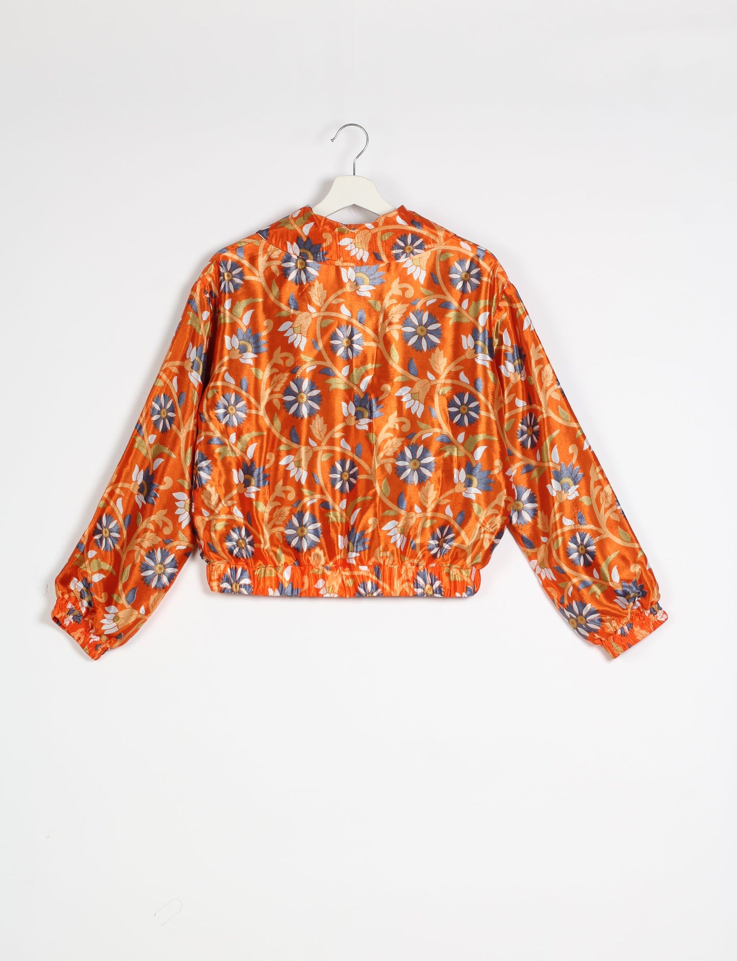 Stylish BOMBER JACKET, an upcycled clothing masterpiece with a cute cropped shape, elasticated details, and detachable metallic zipper. Contrast sari print lining adds a unique touch. Explore sustainable and eco-friendly fashion.