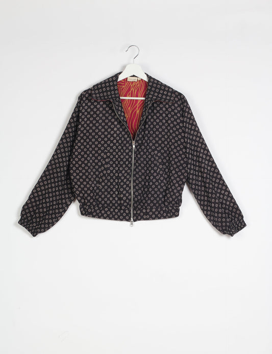 Stylish BOMBER JACKET, an upcycled clothing masterpiece with a cute cropped shape, elasticated details, and detachable metallic zipper. Contrast sari print lining adds a unique touch. Explore sustainable and eco-friendly fashion.