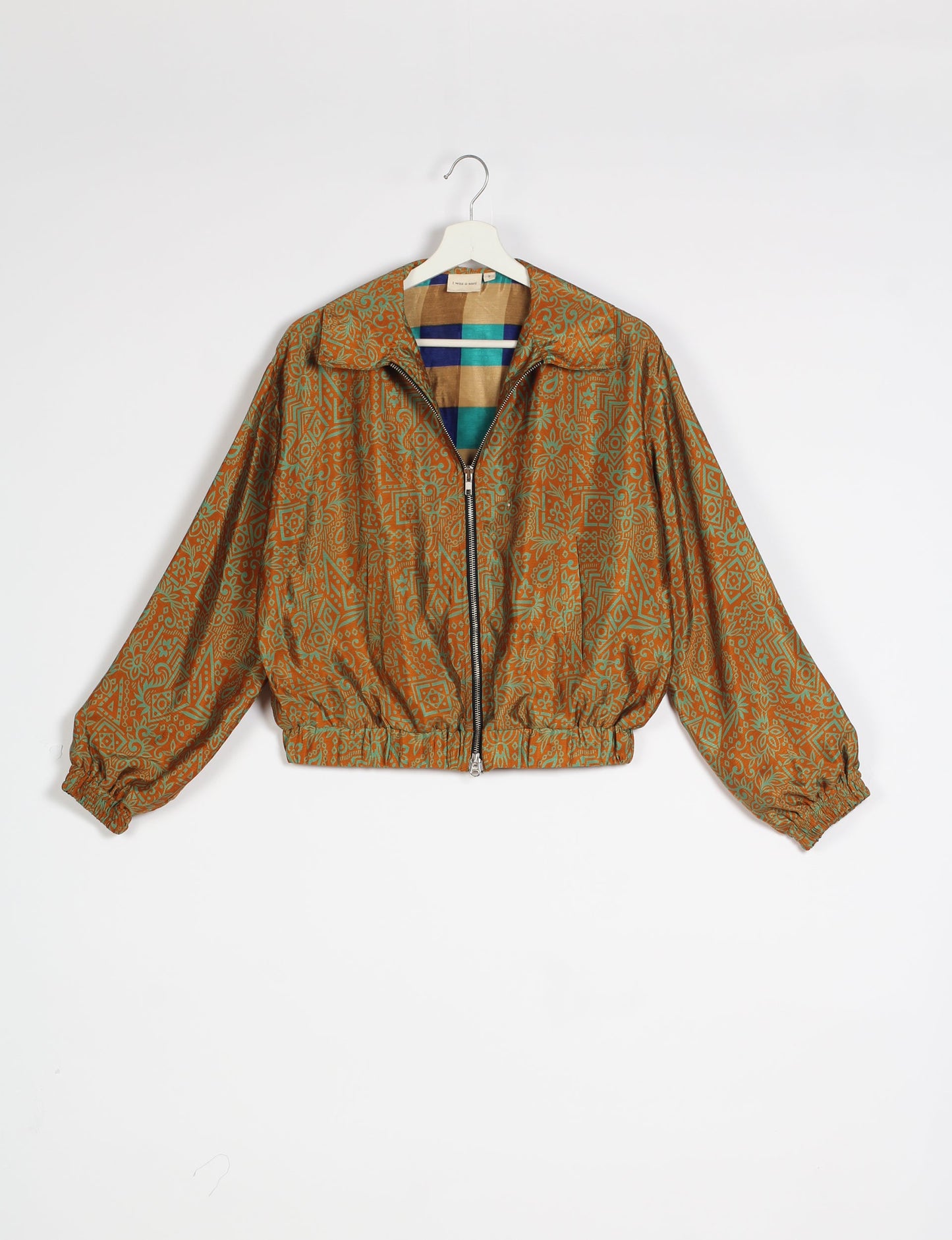 Stylish BOMBER JACKET, an upcycled clothing masterpiece with a cute cropped shape, elasticated details, and detachable metallic zipper. Contrast sari print lining adds a unique touch. Explore sustainable and eco-friendly fashion.