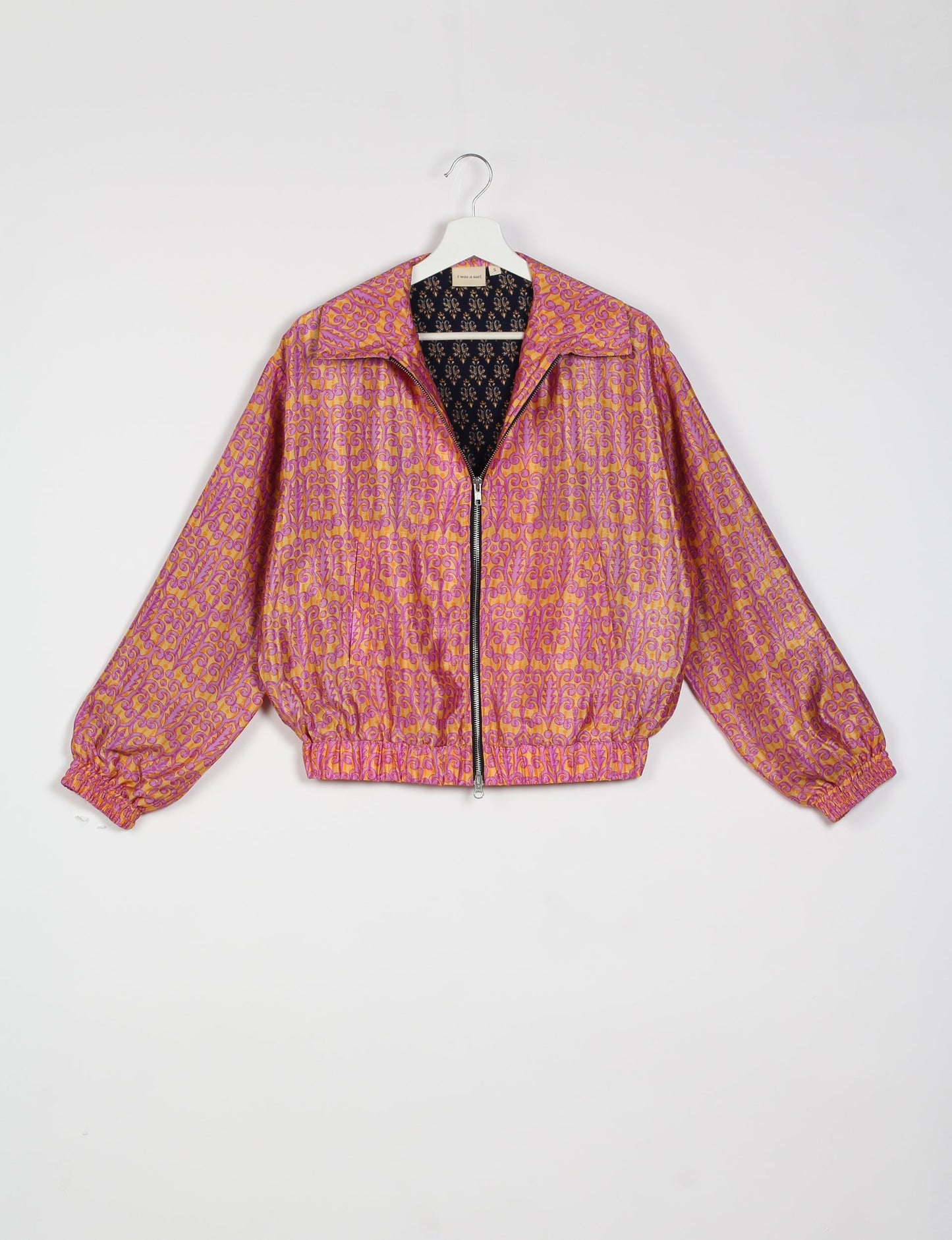 Stylish BOMBER JACKET, an upcycled clothing masterpiece with a cute cropped shape, elasticated details, and detachable metallic zipper. Contrast sari print lining adds a unique touch. Explore sustainable and eco-friendly fashion.