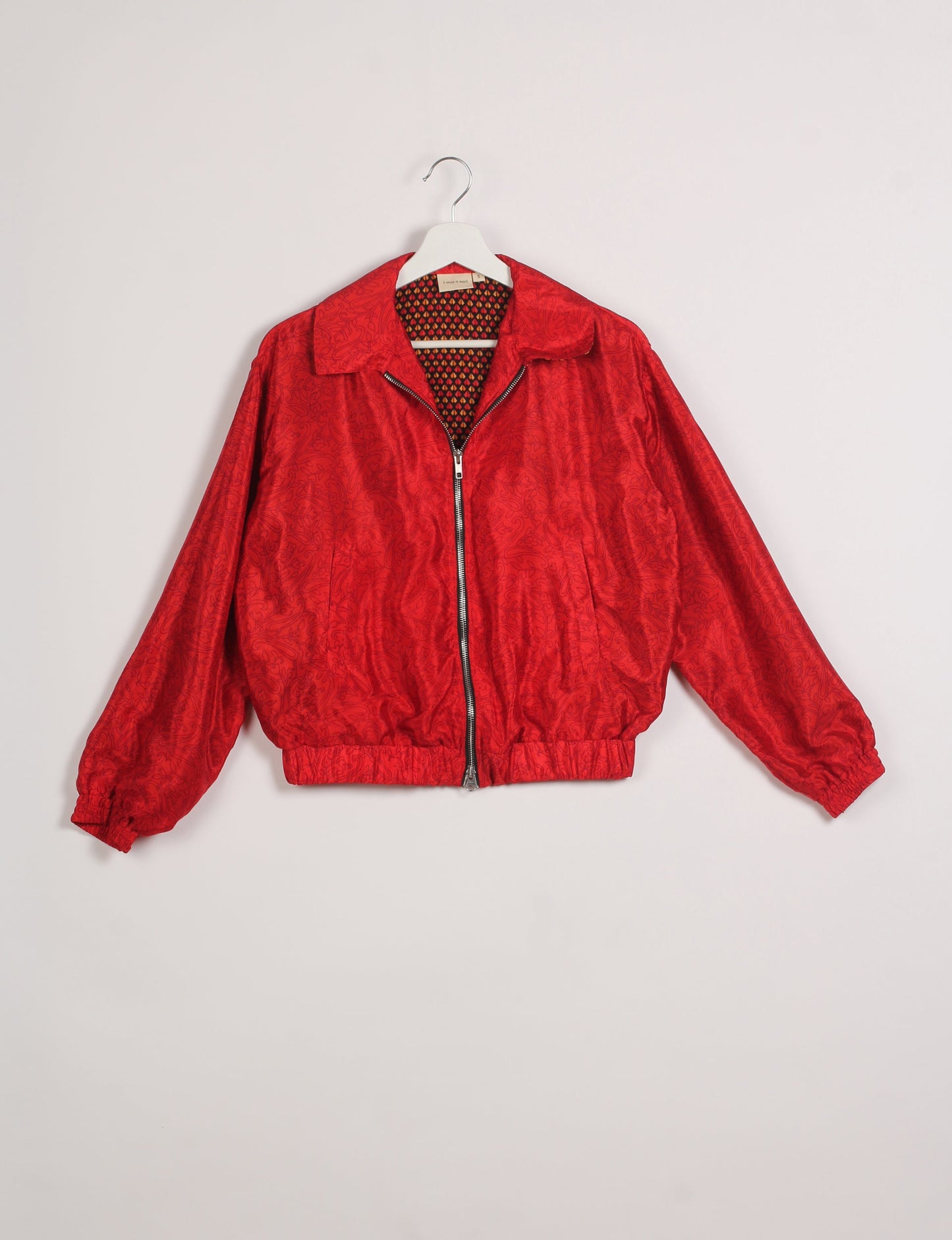 Stylish BOMBER JACKET, an upcycled clothing masterpiece with a cute cropped shape, elasticated details, and detachable metallic zipper. Contrast sari print lining adds a unique touch. Explore sustainable and eco-friendly fashion.