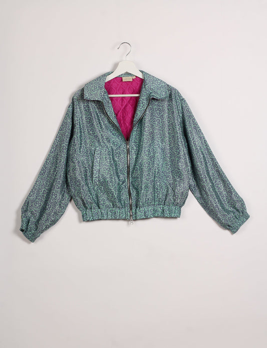 Stylish BOMBER JACKET, an upcycled clothing masterpiece with a cute cropped shape, elasticated details, and detachable metallic zipper. Contrast sari print lining adds a unique touch. Explore sustainable and eco-friendly fashion.