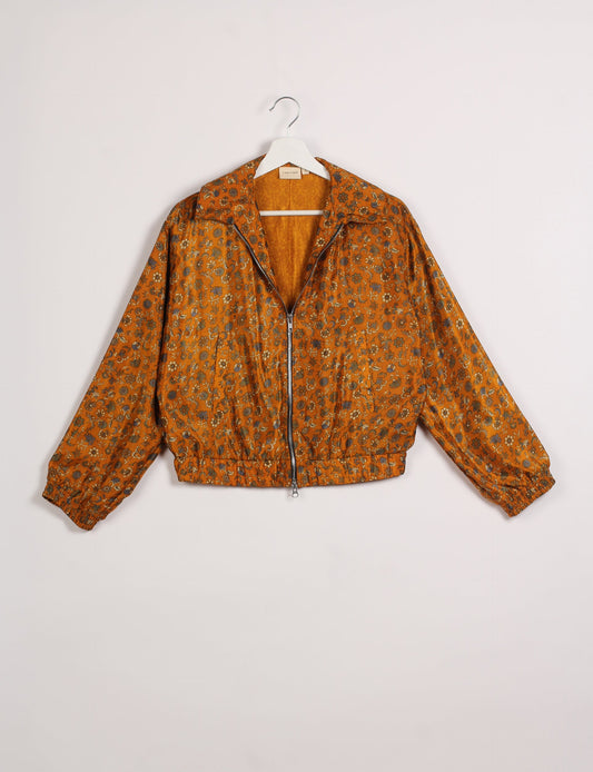 Stylish BOMBER JACKET, an upcycled clothing masterpiece with a cute cropped shape, elasticated details, and detachable metallic zipper. Contrast sari print lining adds a unique touch. Explore sustainable and eco-friendly fashion.