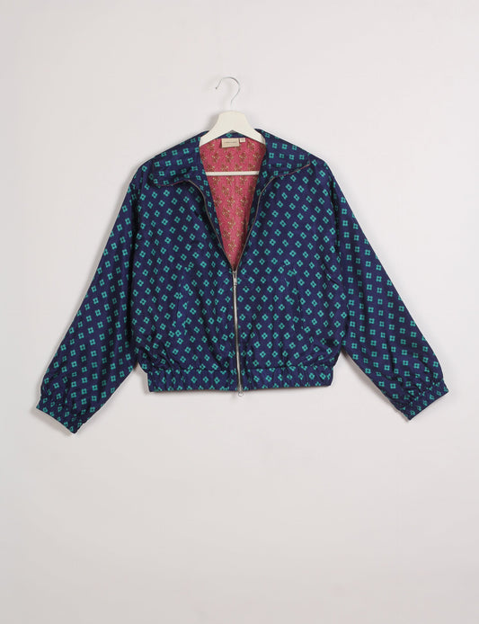 Stylish BOMBER JACKET, an upcycled clothing masterpiece with a cute cropped shape, elasticated details, and detachable metallic zipper. Contrast sari print lining adds a unique touch. Explore sustainable and eco-friendly fashion.