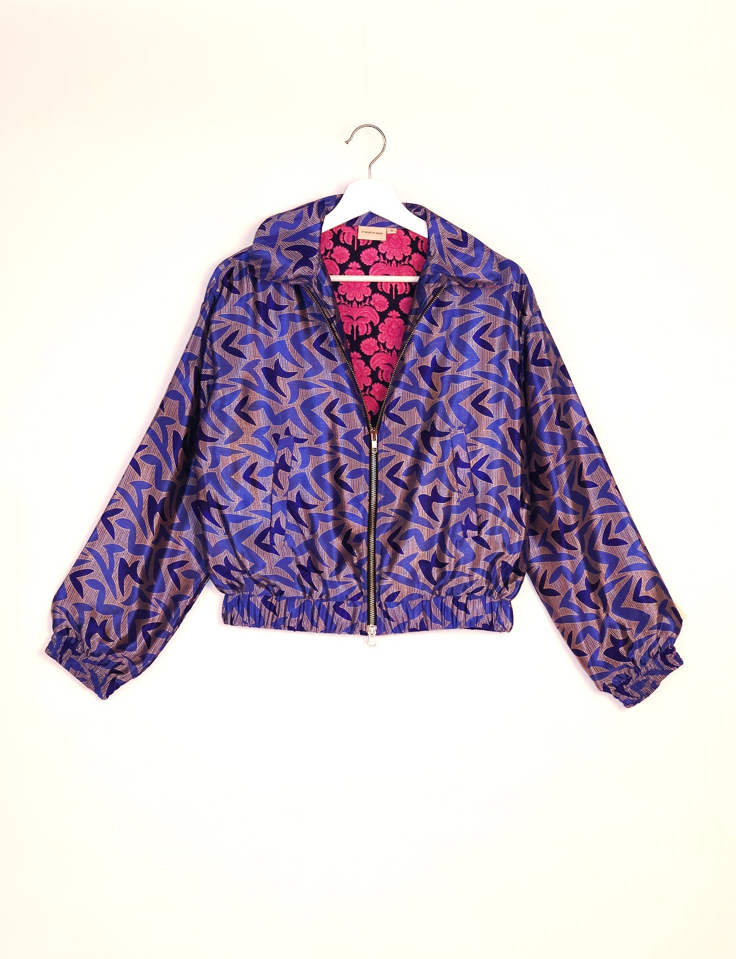 Stylish BOMBER JACKET, an upcycled clothing masterpiece with a cute cropped shape, elasticated details, and detachable metallic zipper. Contrast sari print lining adds a unique touch. Explore sustainable and eco-friendly fashion.