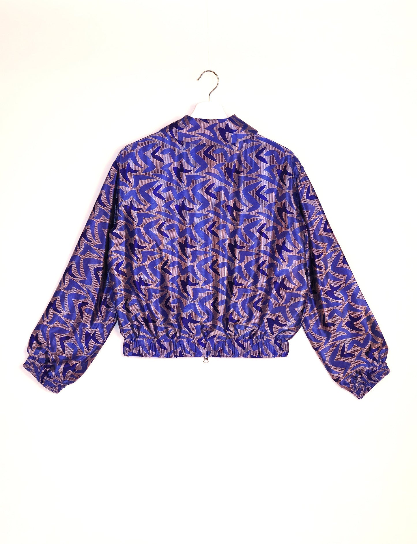 Stylish BOMBER JACKET, an upcycled clothing masterpiece with a cute cropped shape, elasticated details, and detachable metallic zipper. Contrast sari print lining adds a unique touch. Explore sustainable and eco-friendly fashion.