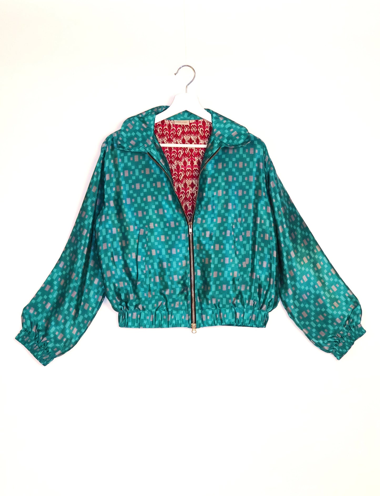 Stylish BOMBER JACKET, an upcycled clothing masterpiece with a cute cropped shape, elasticated details, and detachable metallic zipper. Contrast sari print lining adds a unique touch. Explore sustainable and eco-friendly fashion.