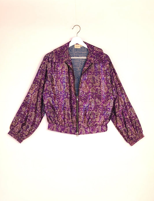 Stylish BOMBER JACKET, an upcycled clothing masterpiece with a cute cropped shape, elasticated details, and detachable metallic zipper. Contrast sari print lining adds a unique touch. Explore sustainable and eco-friendly fashion.