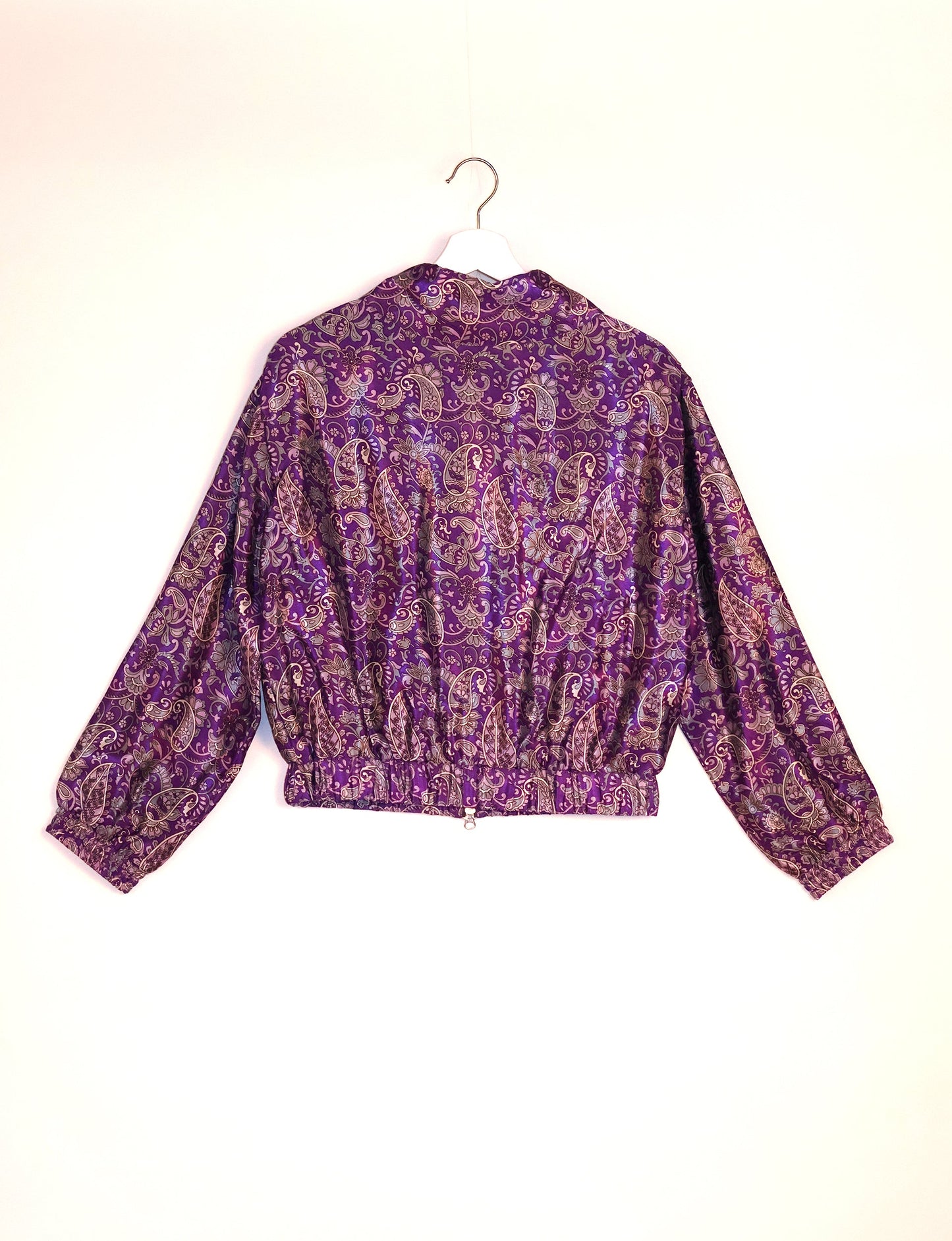 Stylish BOMBER JACKET, an upcycled clothing masterpiece with a cute cropped shape, elasticated details, and detachable metallic zipper. Contrast sari print lining adds a unique touch. Explore sustainable and eco-friendly fashion.