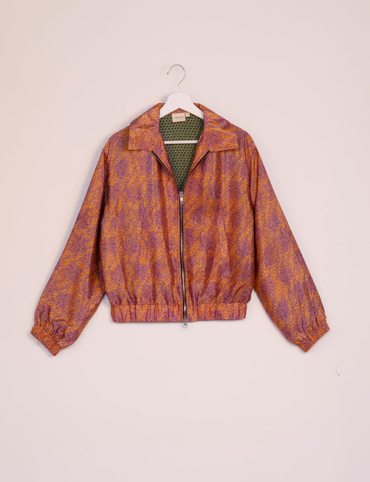 Stylish BOMBER JACKET, an upcycled clothing masterpiece with a cute cropped shape, elasticated details, and detachable metallic zipper. Contrast sari print lining adds a unique touch. Explore sustainable and eco-friendly fashion.