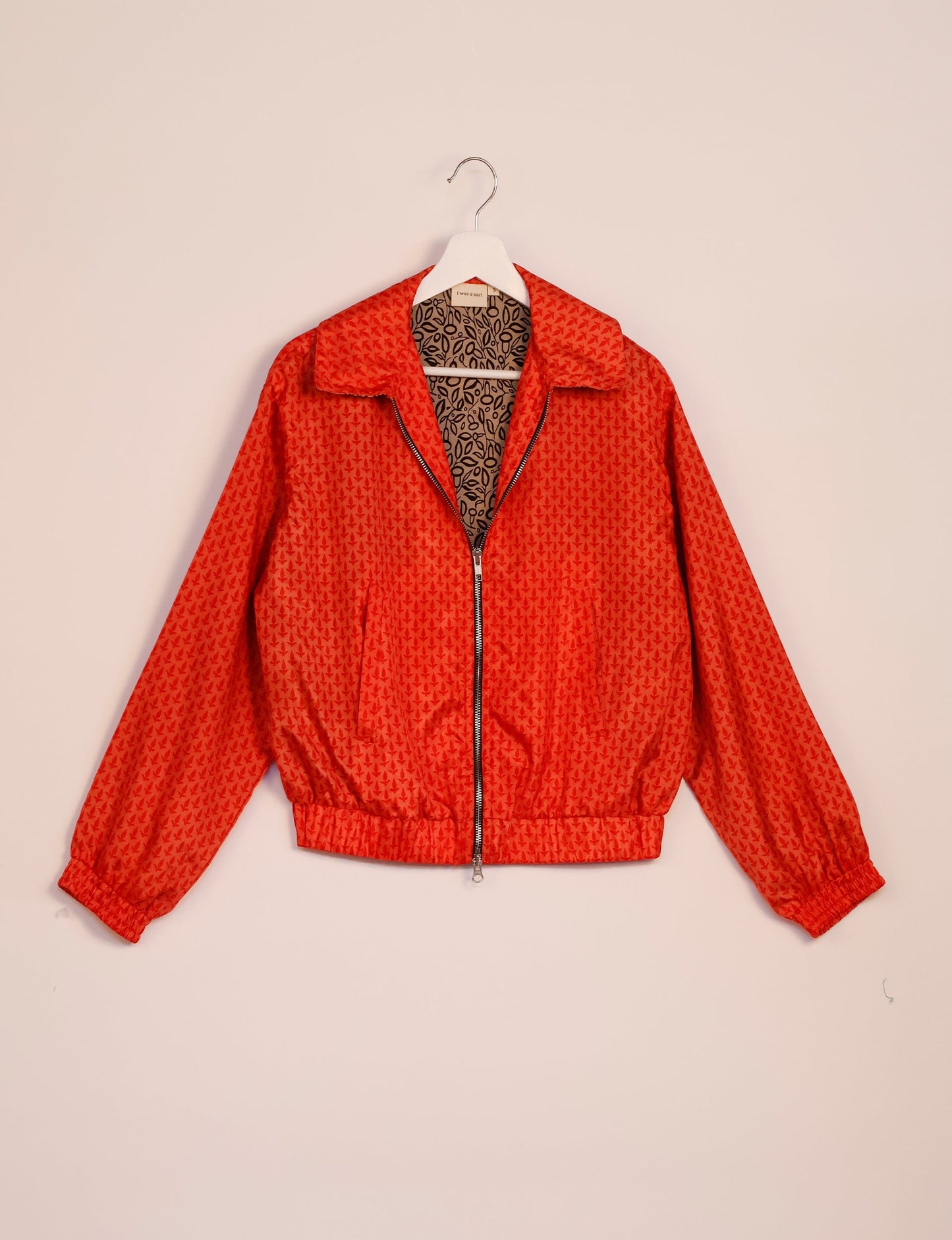 Stylish BOMBER JACKET, an upcycled clothing masterpiece with a cute cropped shape, elasticated details, and detachable metallic zipper. Contrast sari print lining adds a unique touch. Explore sustainable and eco-friendly fashion.